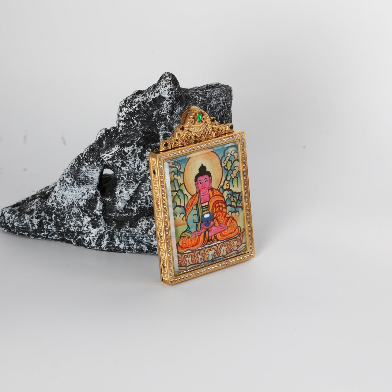 The Nepal Elegant Amitabha Thangka pendant displayed as a sacred amulet for liberation and peace, embodying Tibetan Buddhist tradition.


