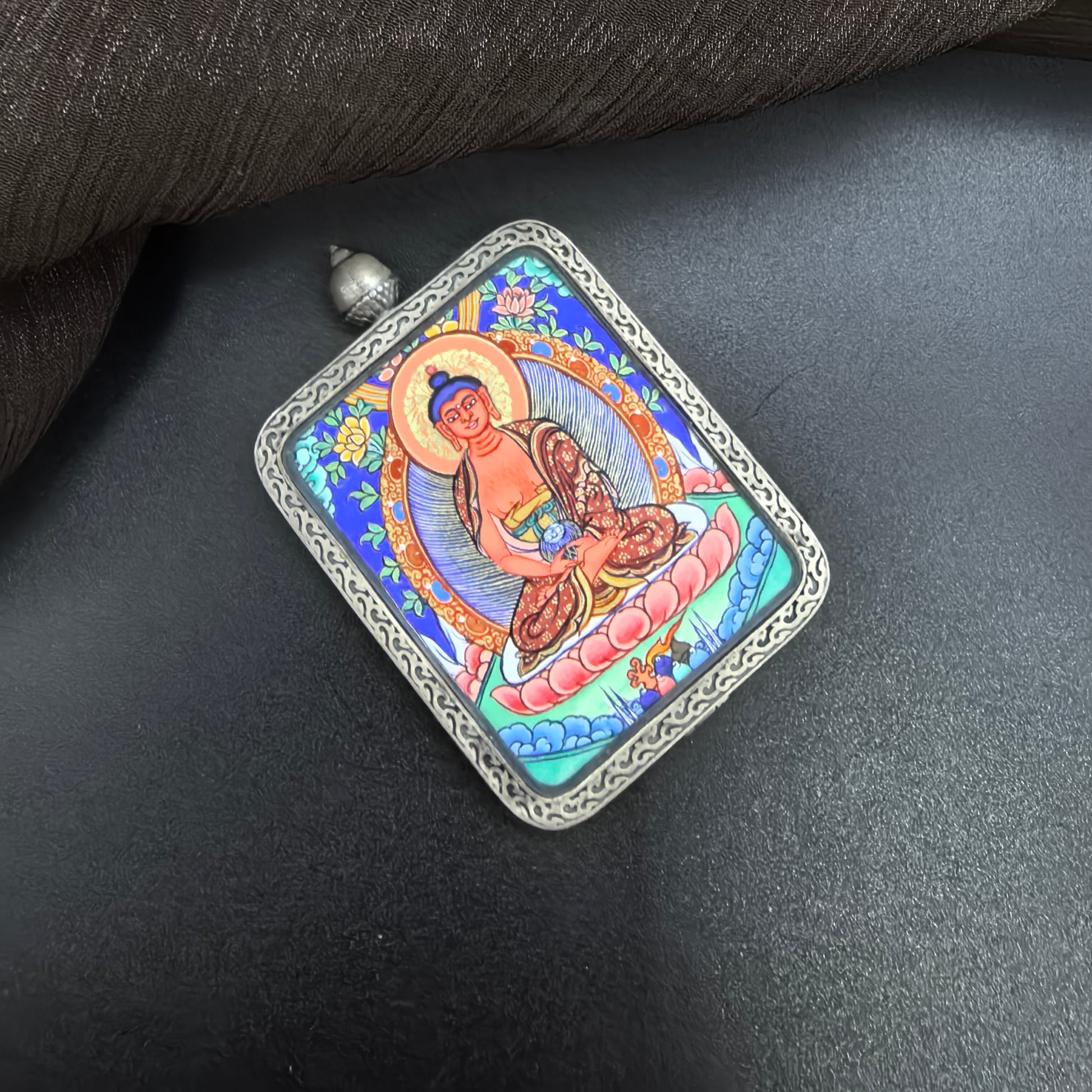 A 3.5x4.5cm hand-painted Rekong Amitabha (阿弥陀佛) Thangka pendant with 925 silver featuring the Buddha of the Western Pure Land, representing liberation and blessing in Buddhist tradition.

