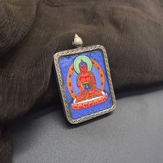 A 3.5x4.5cm hand-painted Rekong Blue Thangka Amitabha (阿弥陀佛) Thangka pendant with 925 silver featuring the lord of the Western Pure Land, representing liberation and blessing in Buddhist tradition.
