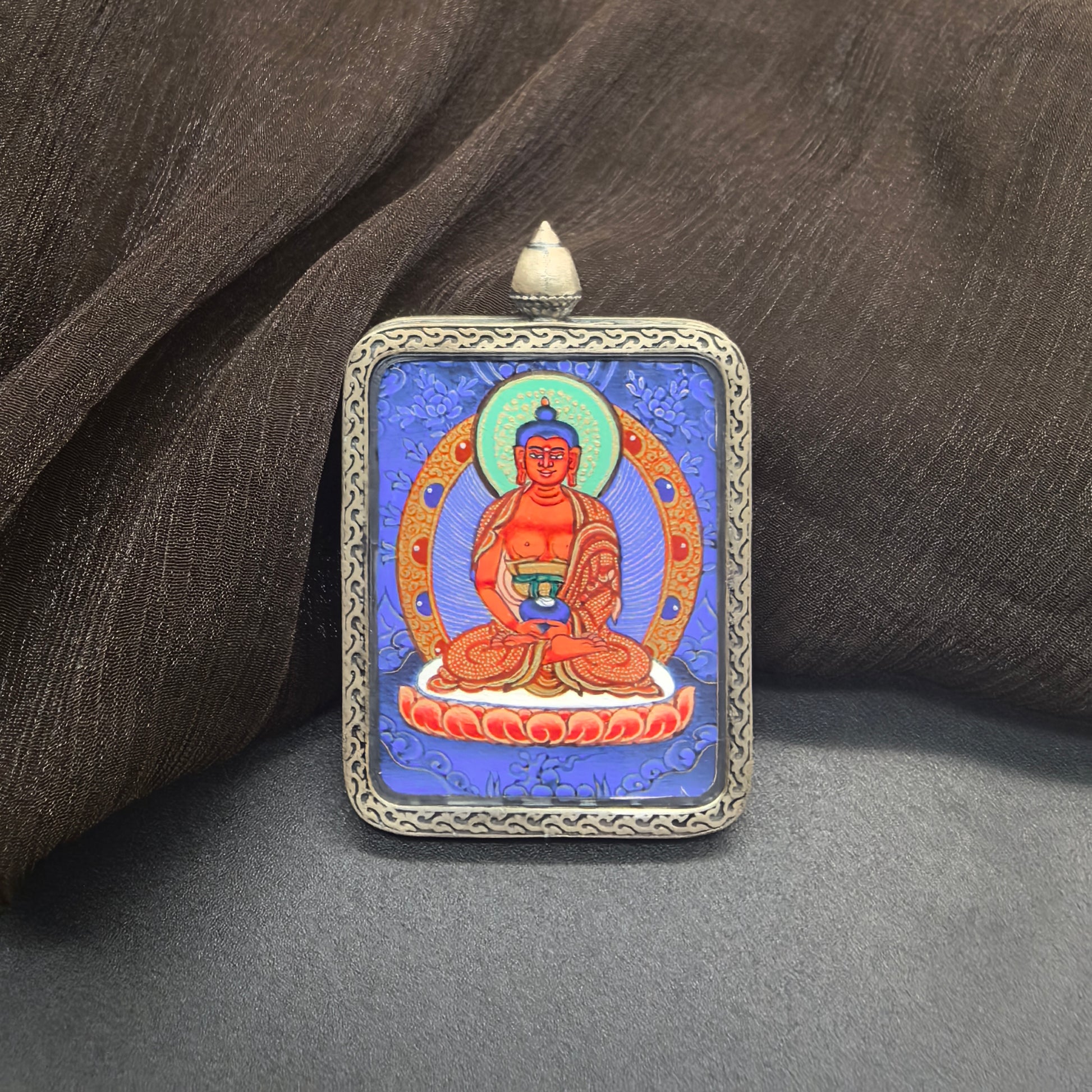 Close-up detail of the Rekong Blue Thangka Amitabha painting showing natural mineral pigments, showcasing the masterful artistry of Rekong lama painters.
