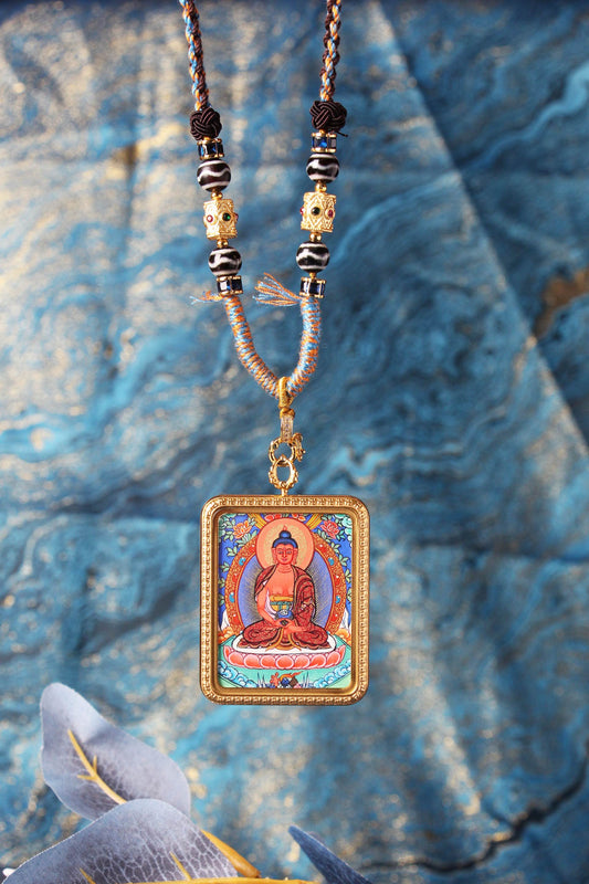 The Tibetan Buddhist Amitabha Buddha Thangka pendant displayed as a sacred amulet for longevity, wisdom, and Pure Land rebirth, embodying the infinite light and compassionate protection of Tibetan Buddhist tradition.
