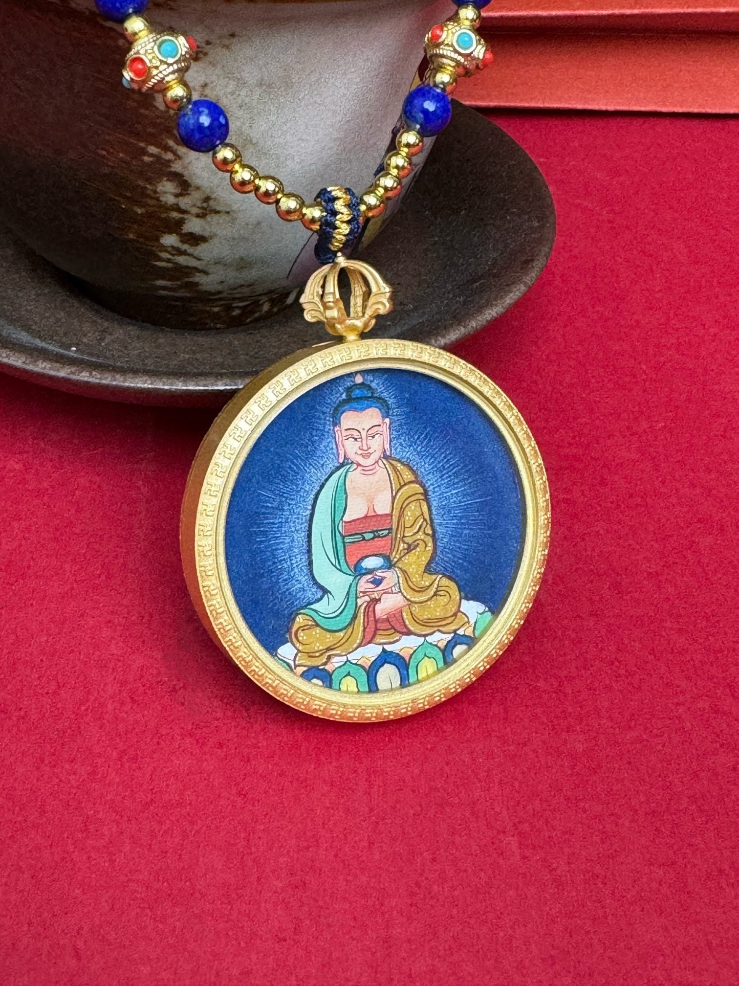 Detailed view of the refined copper casing for the Amitabha Thangka pendant, symbolising peace and tradition in Buddhist practice.
