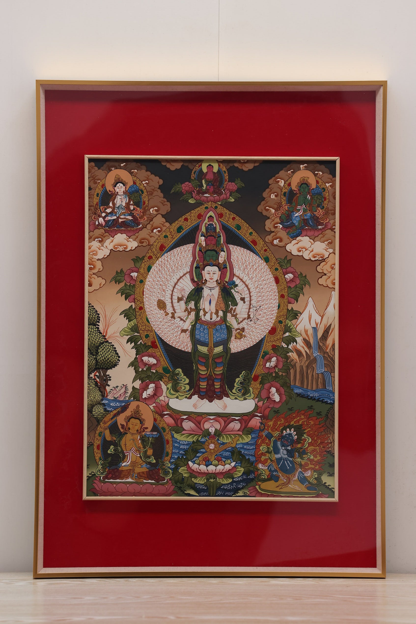 Alt Text: Handcrafted Thangka of the Bodhisattva with a Thousand Hands and Eyes, representing universal compassion.