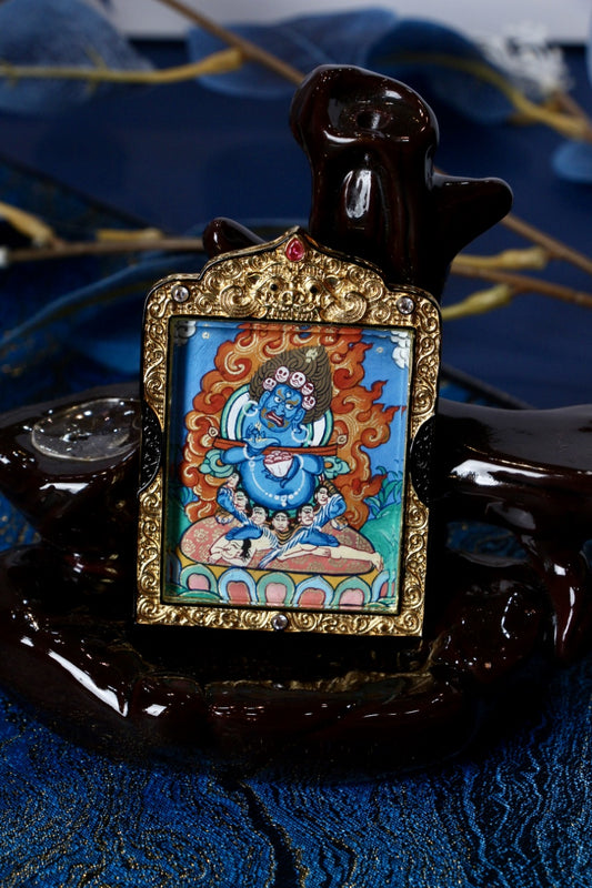 Vaishravana thangka pendant depicting a Tibetan Buddhist wealth protector deity associated with prosperity, protection, and abundance.