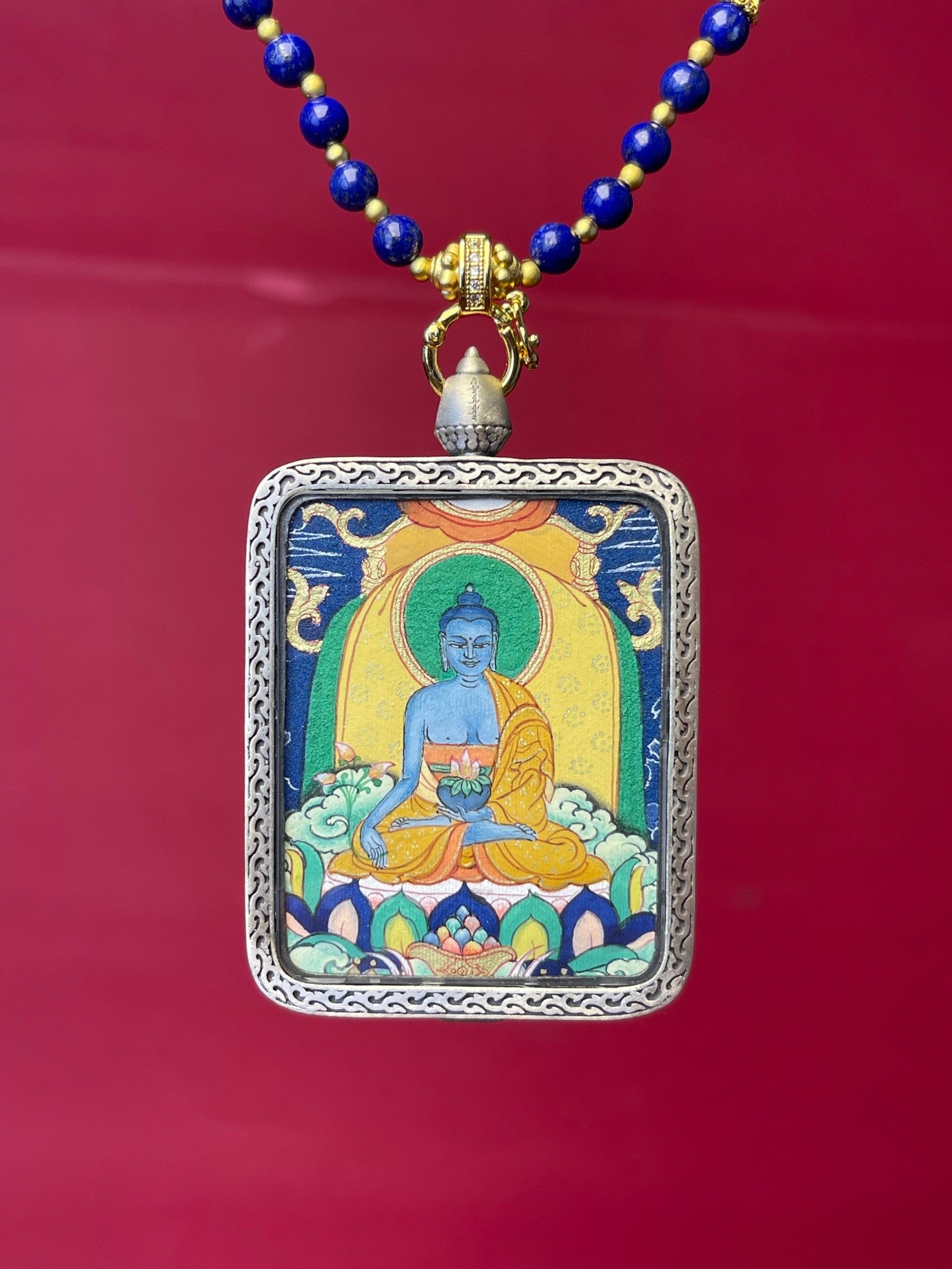 Detailed view of the silver casing for the Bhaisajyaguru Thangka pendant, symbolising healing and tradition in Buddhist practice.
