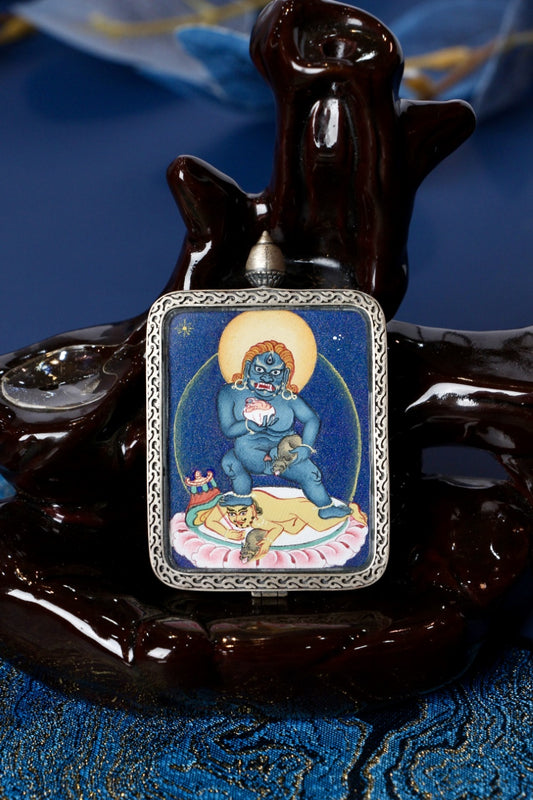 Black Jambhala thangka pendant depicting the Tibetan Buddhist deity of wealth, protection, and prosperity.