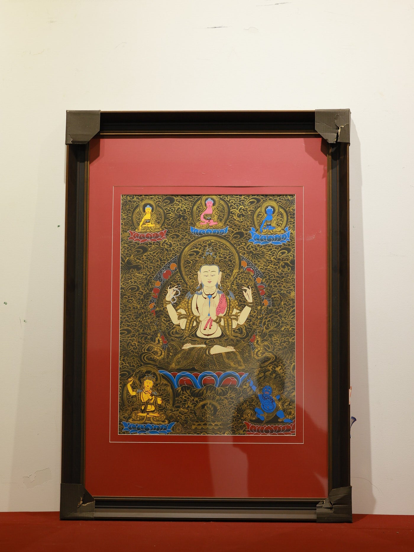 Detailed view of Black Gold Four-Armed Avalokiteshvara Thangka, showing intricate gold accents and sacred symbols.