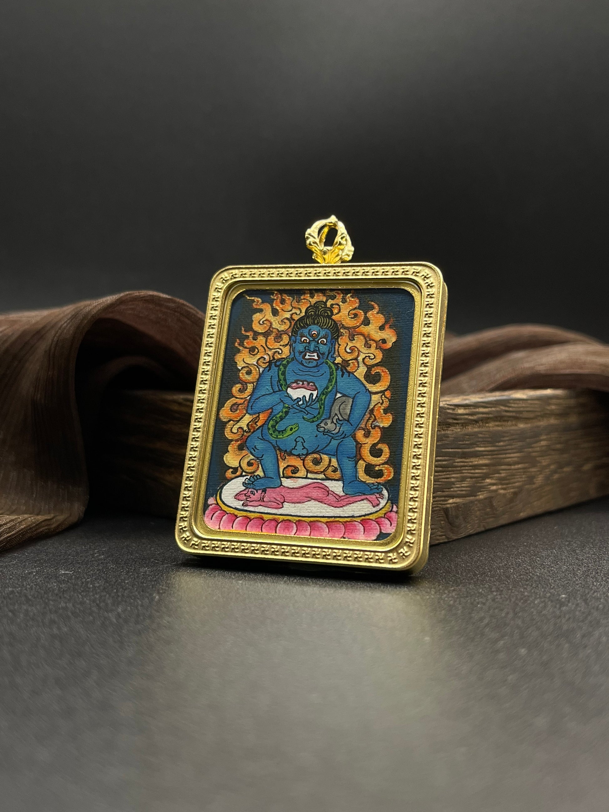 Close-up detail of the Nepal Black Jambhala Thangka showing hand-painted mineral pigments, showcasing the masterful artistry.

