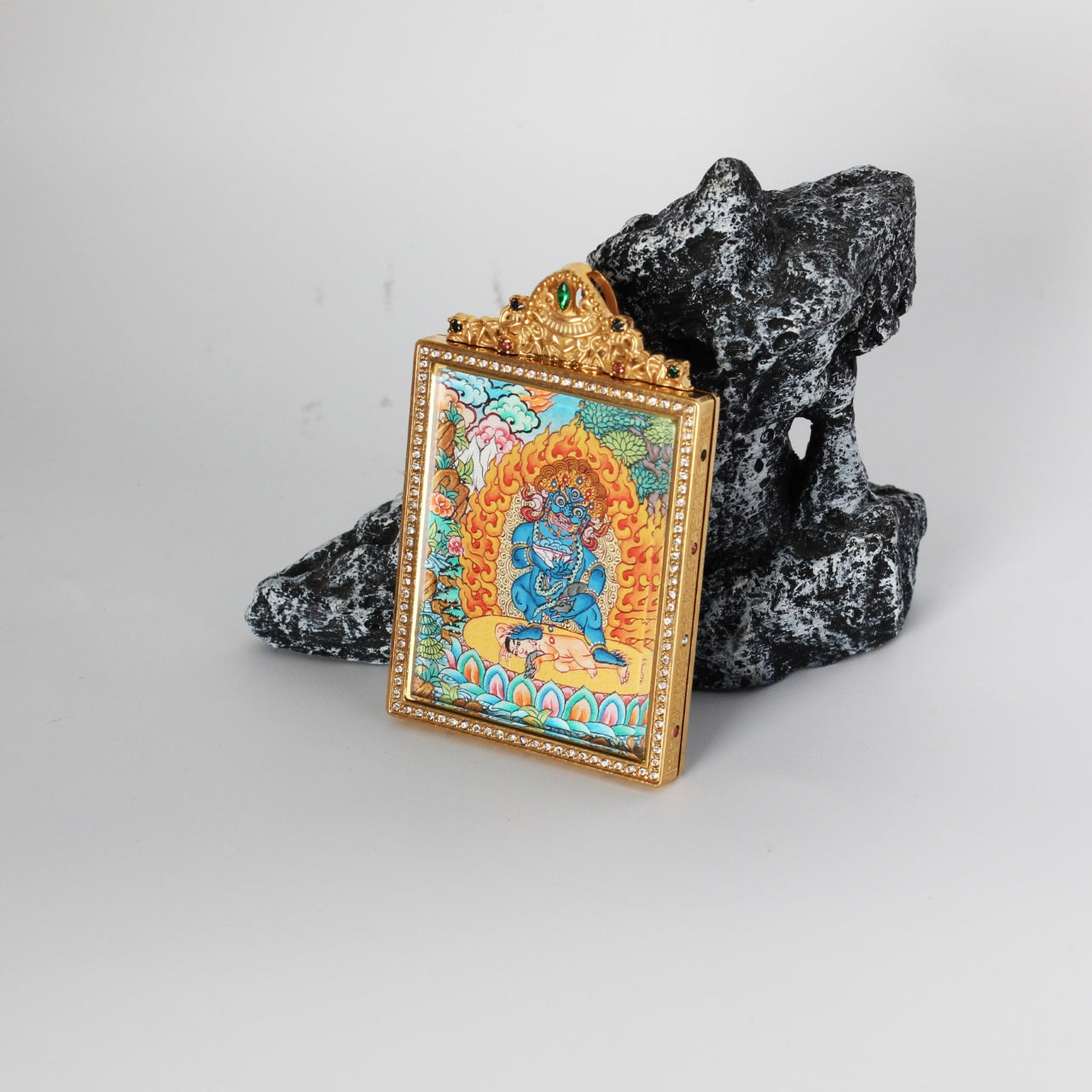 The Nepal Premium Black Jambhala Thangka pendant displayed as a sacred amulet for swift wealth and protection, embodying Tibetan Buddhist tradition.

