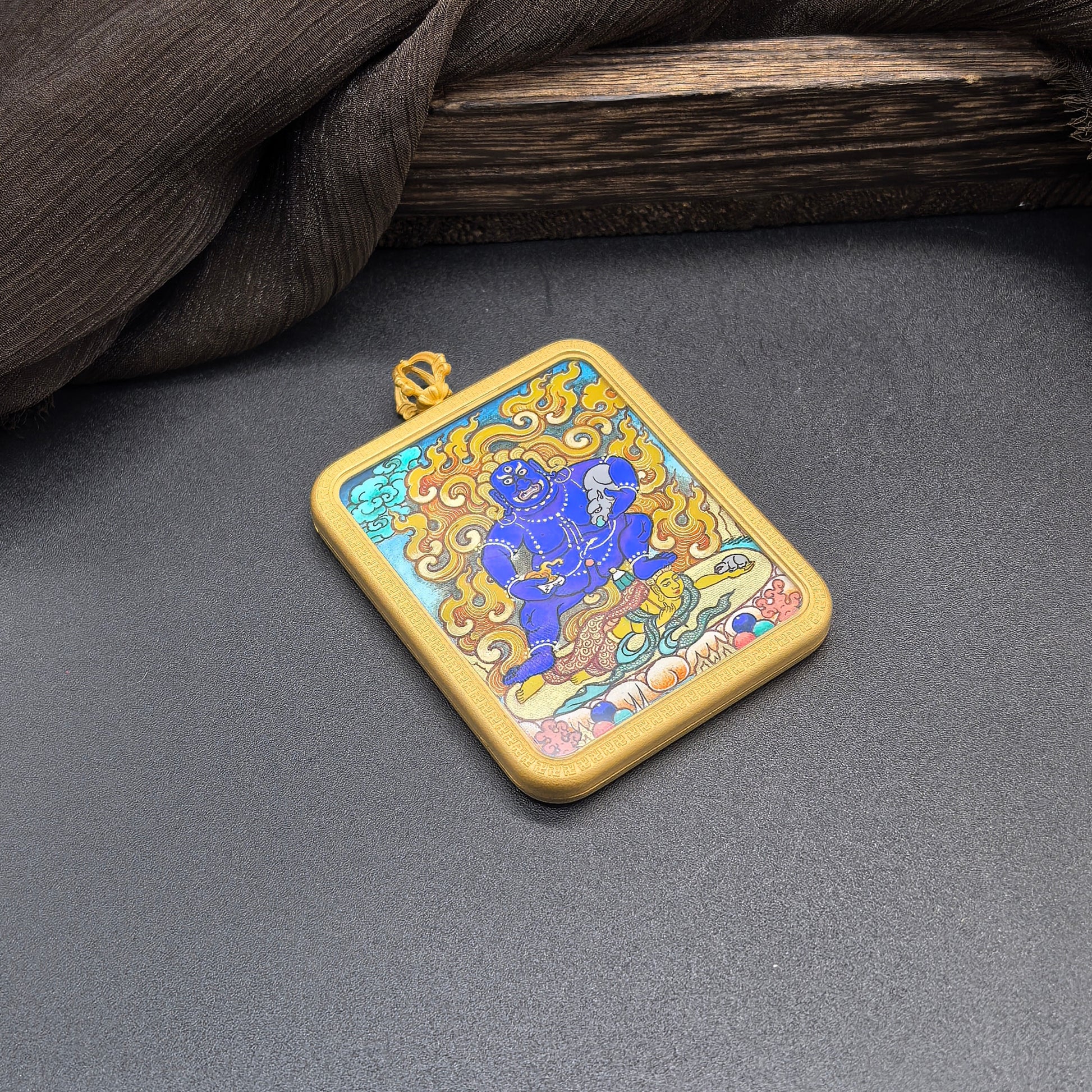 The Rekong Black Jambhala Thangka pendant displayed as a sacred amulet for swift wealth and the relief of poverty, embodying Buddhist tradition.

