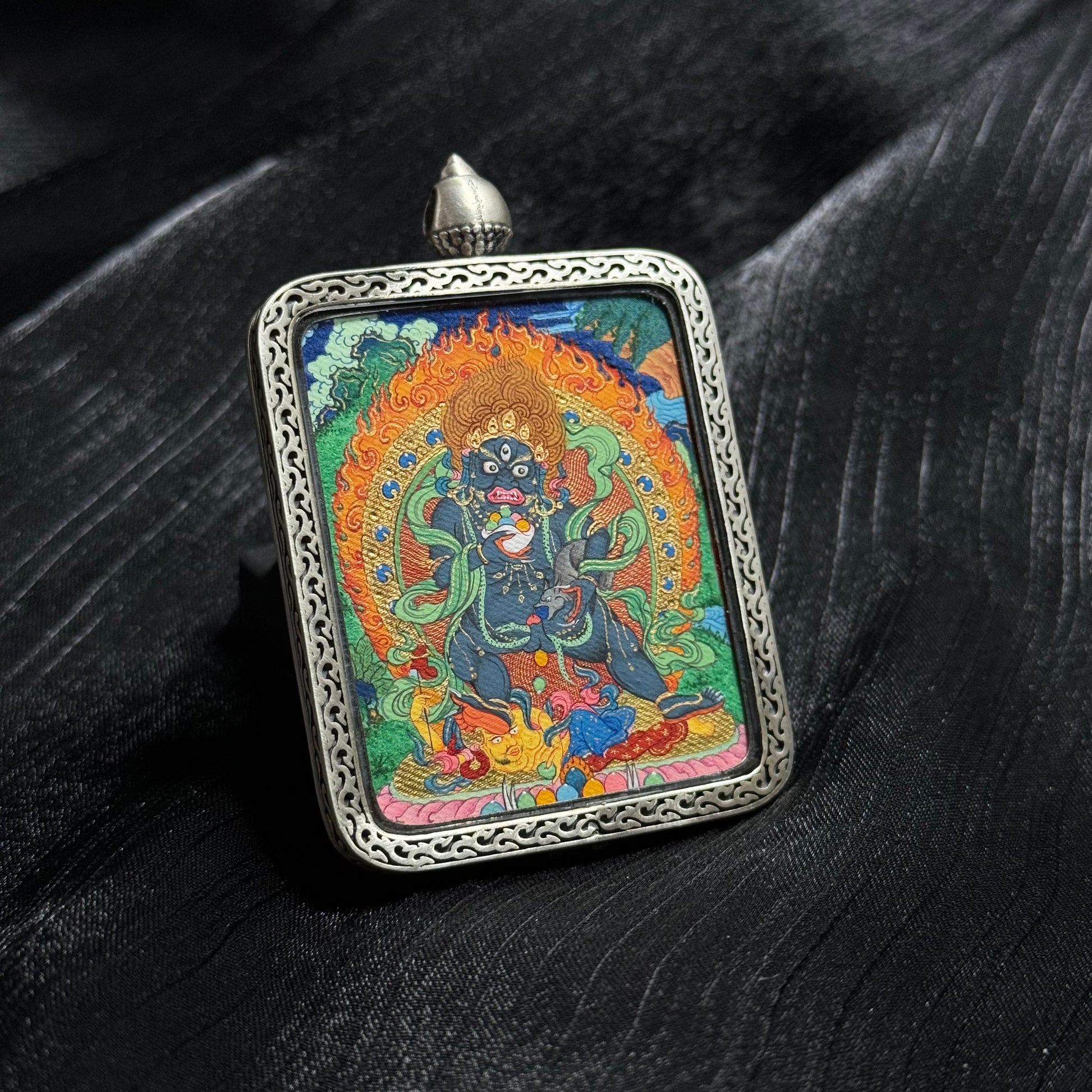  A 4x5cm hand-painted Tibet Mensar Black Jambhala Thangka pendant, representing wealth and protection from petty persons.

