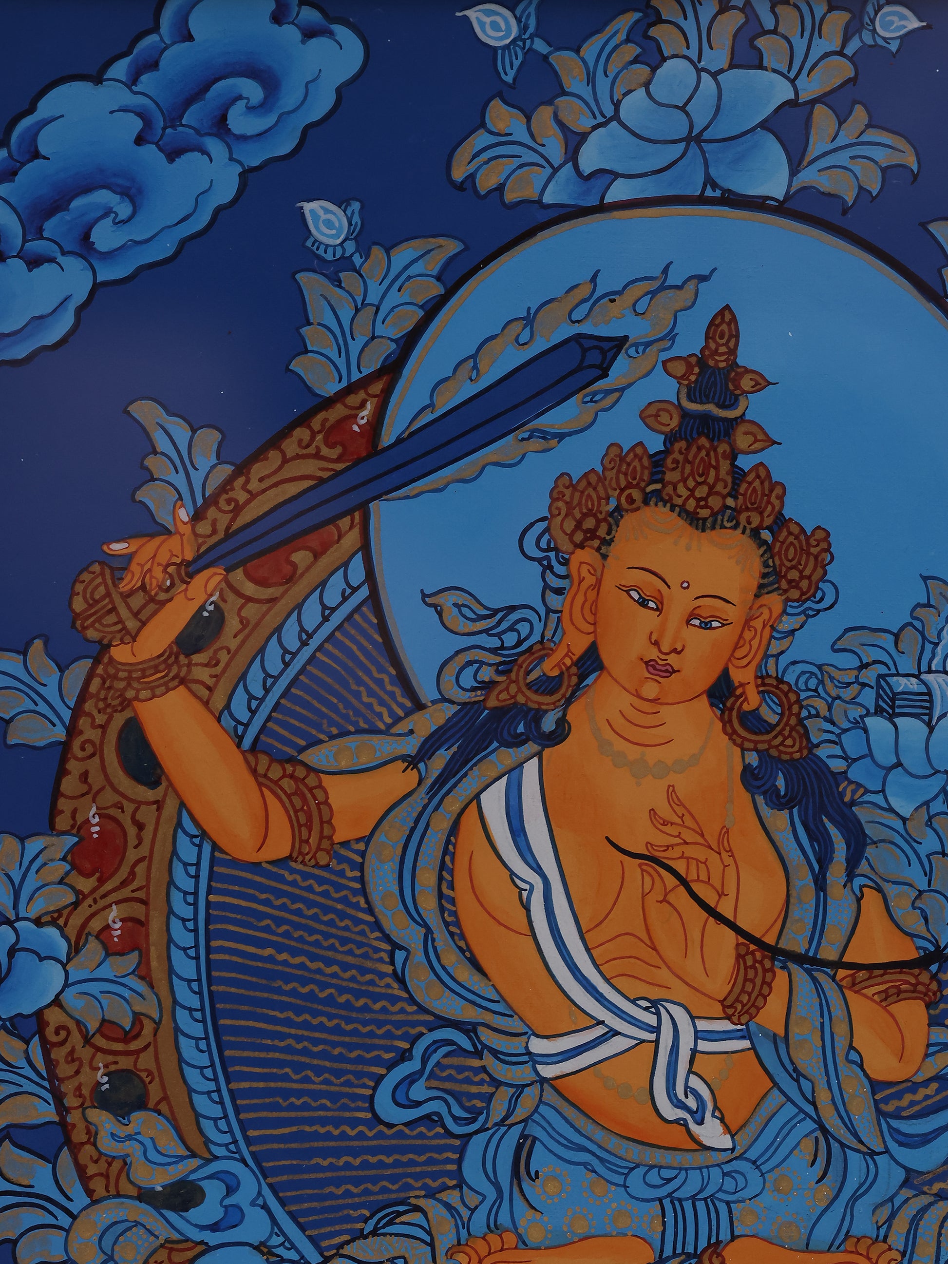 Traditional Tibetan Buddhist blue thangka featuring Manjushri Bodhisattva seated on a lotus throne.