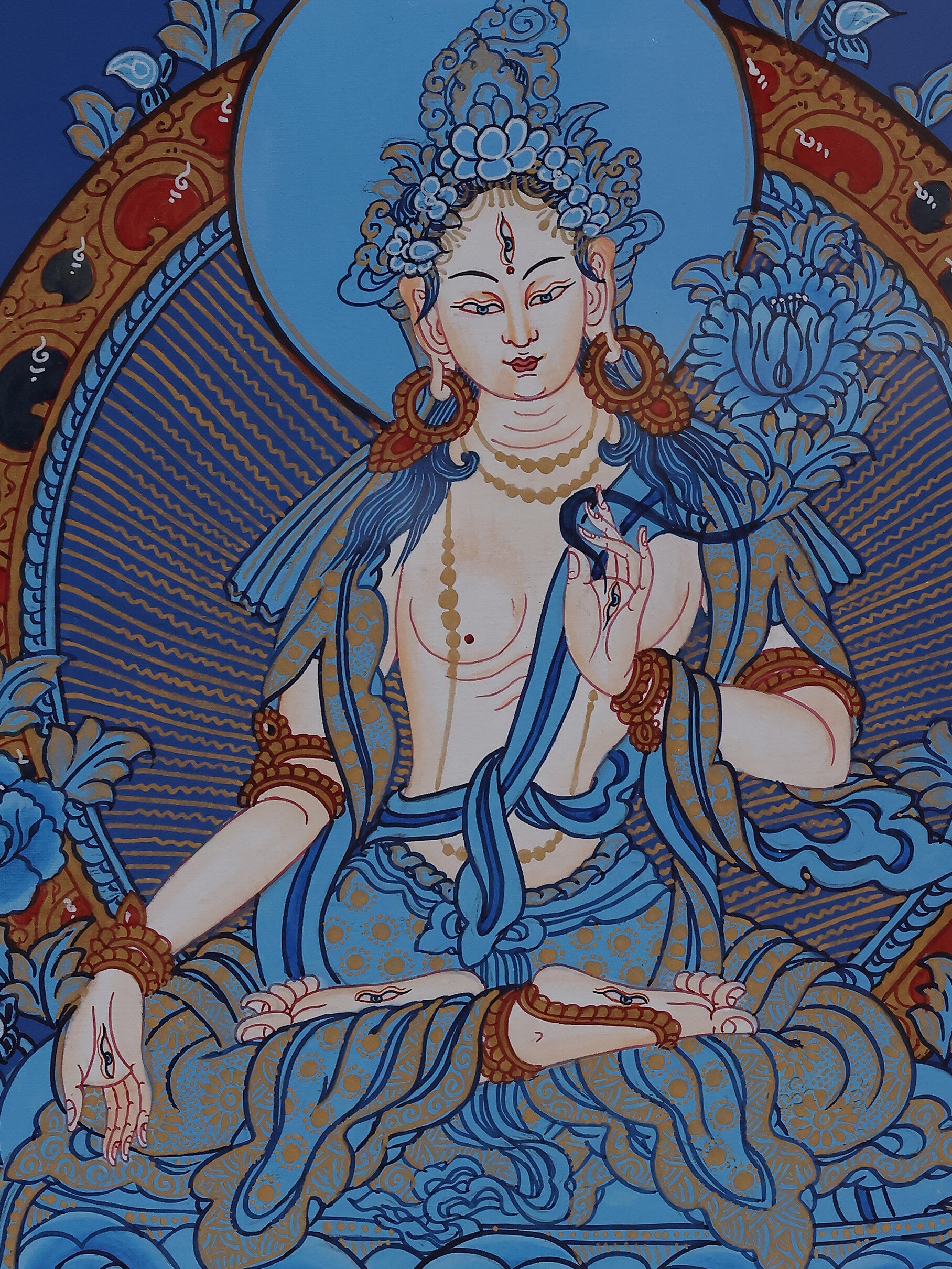 White Tara seated on a deep blue background Thangka, representing healing blessings and longevity in Tibetan Buddhism.