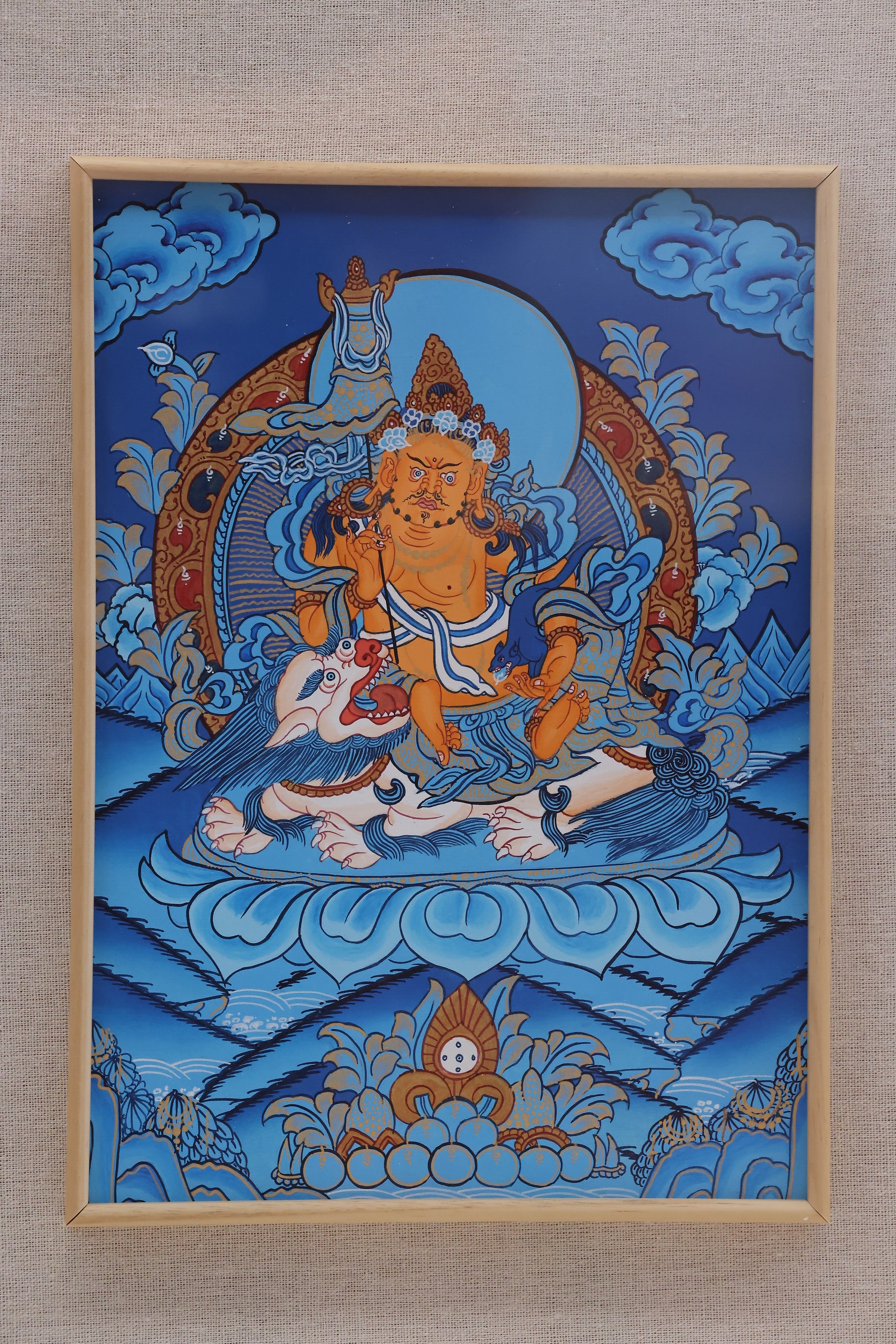 Alt text: Blue Treasure King deity Thangka art, traditional Tibetan Buddhist painting symbolizing wealth, protection, and divine power.