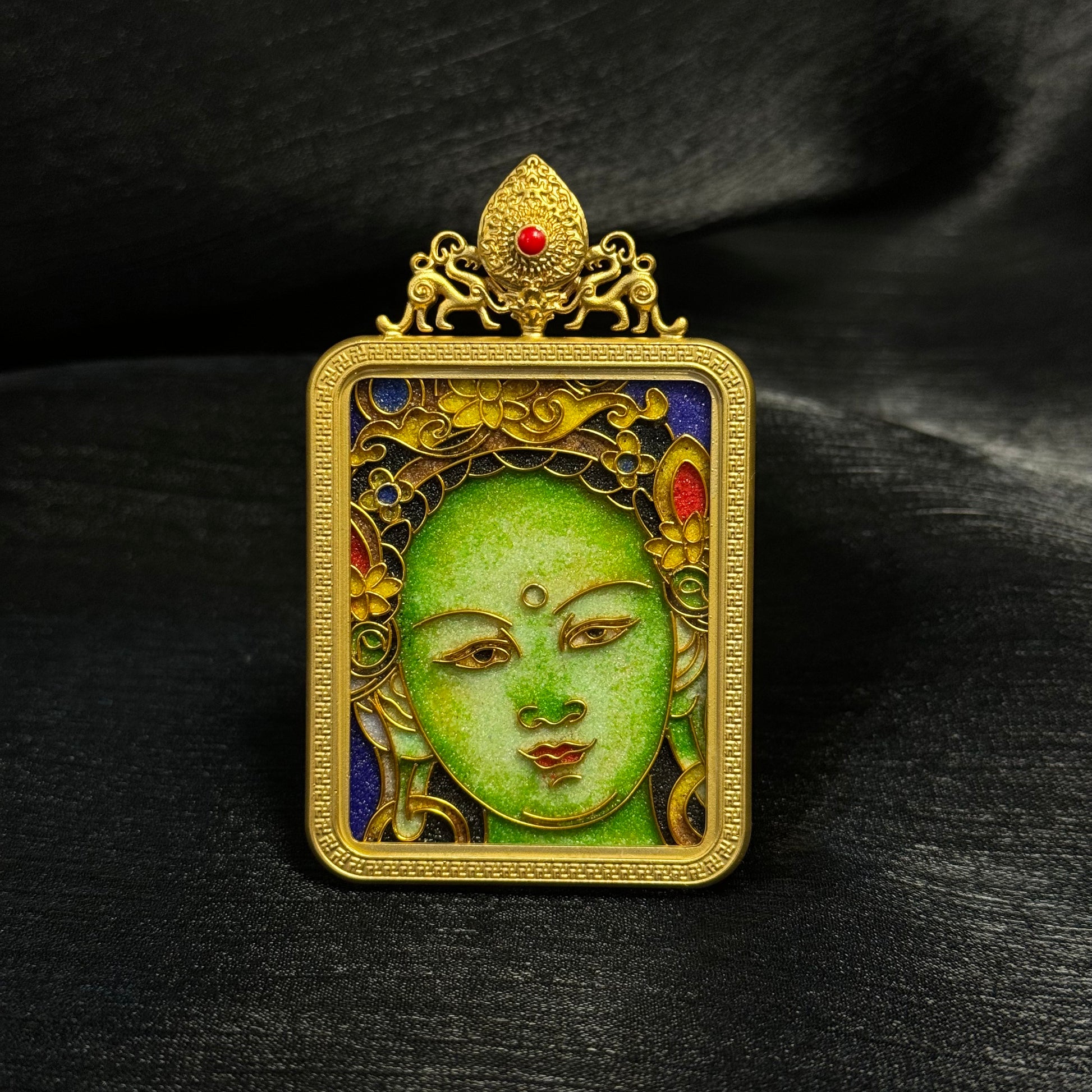 Detailed view of the copper 24K gold-plated casing for the Green Tara cloisonné Thangka pendant.

