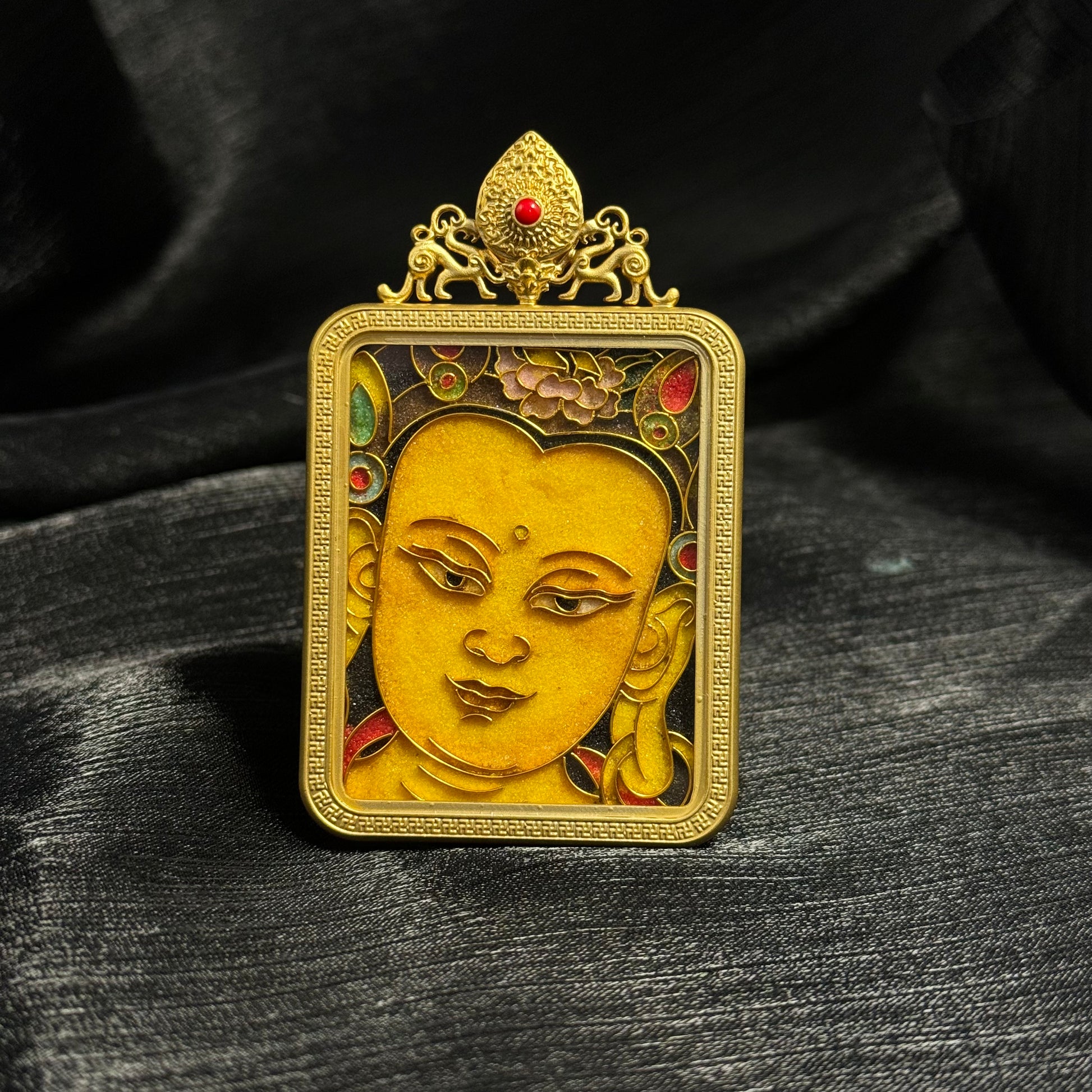 Detailed view of the copper 24K gold-plated casing for the Manjushri cloisonné Thangka pendant.

