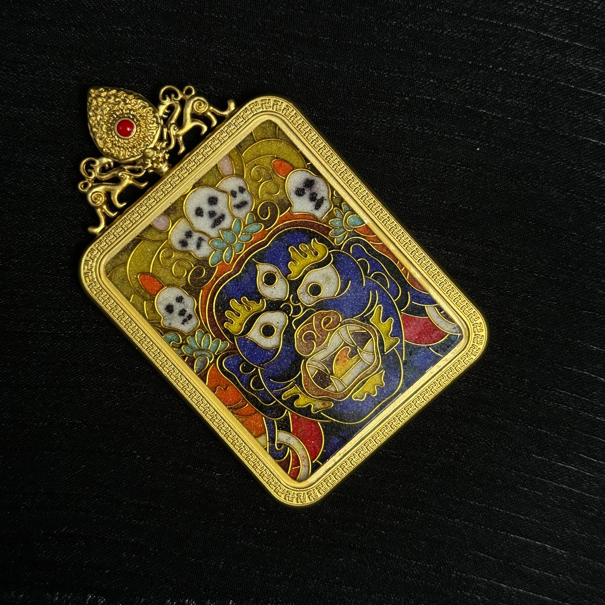  The cloisonné Palden Lhamo Thangka pendant displayed as a sacred amulet for Dharma protection and blessing.
