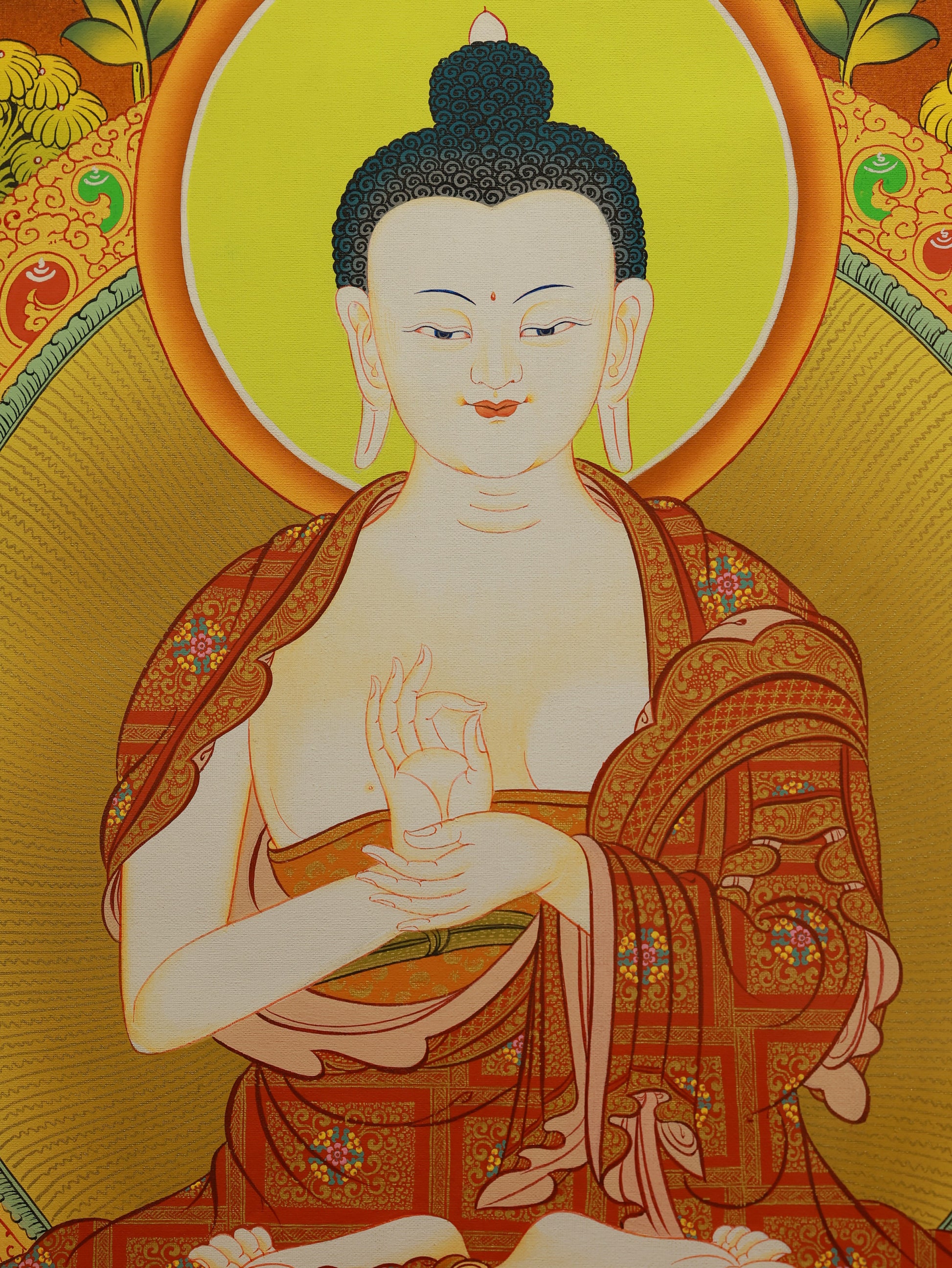 Vibrant Tibetan Thangka of Dainichi Buddha painted with rich natural mineral pigments, traditional Buddhist art.