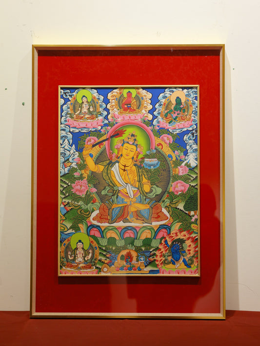 A detailed gold-painted thangka of Manjushri within a mandala design, surrounded by auspicious symbols and vibrant Tibetan artistic patterns.