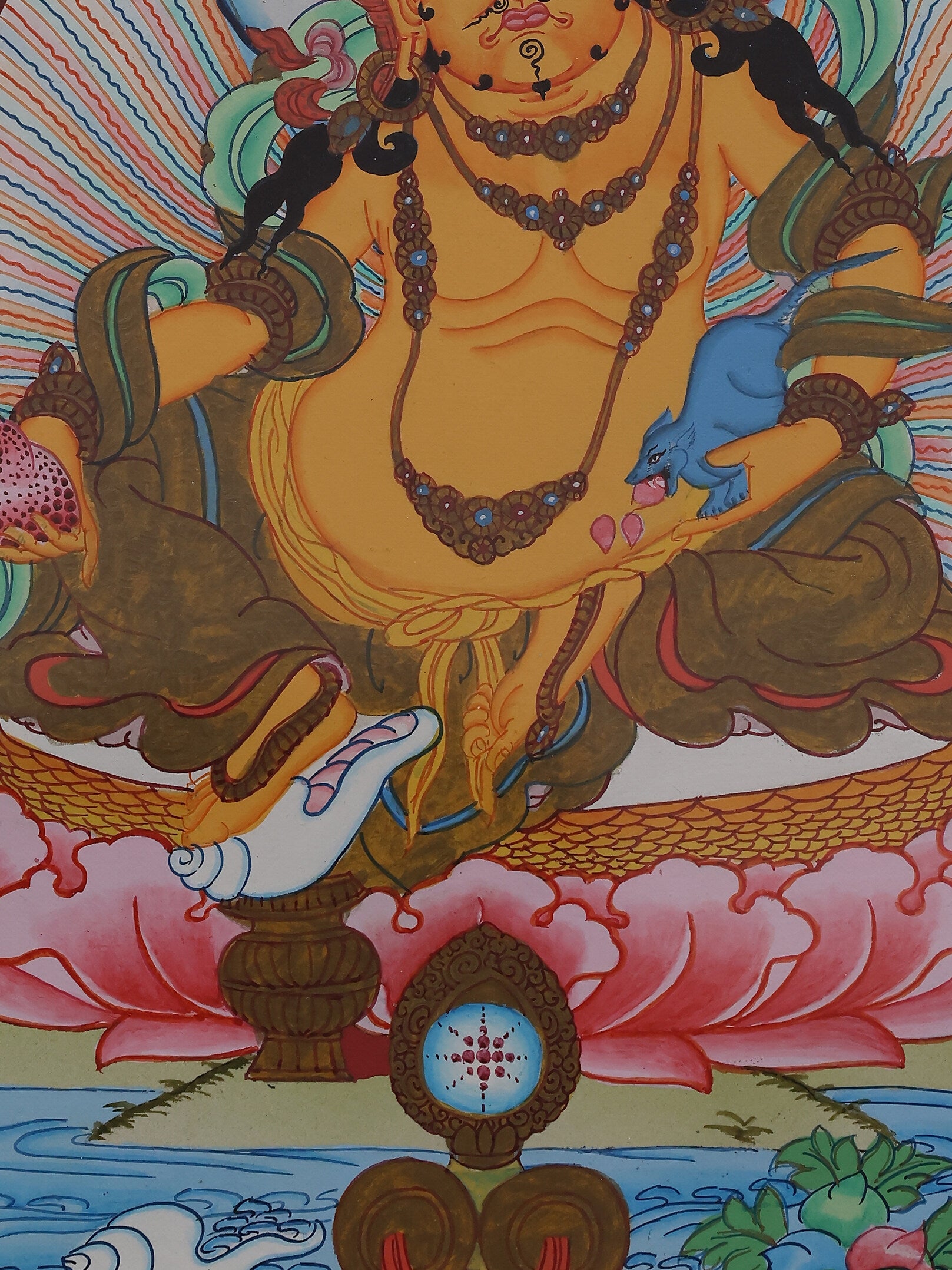 Colored Tibetan thangka art of Yellow Jambhala, the Buddhist god of wealth, painted in traditional Himalayan style.