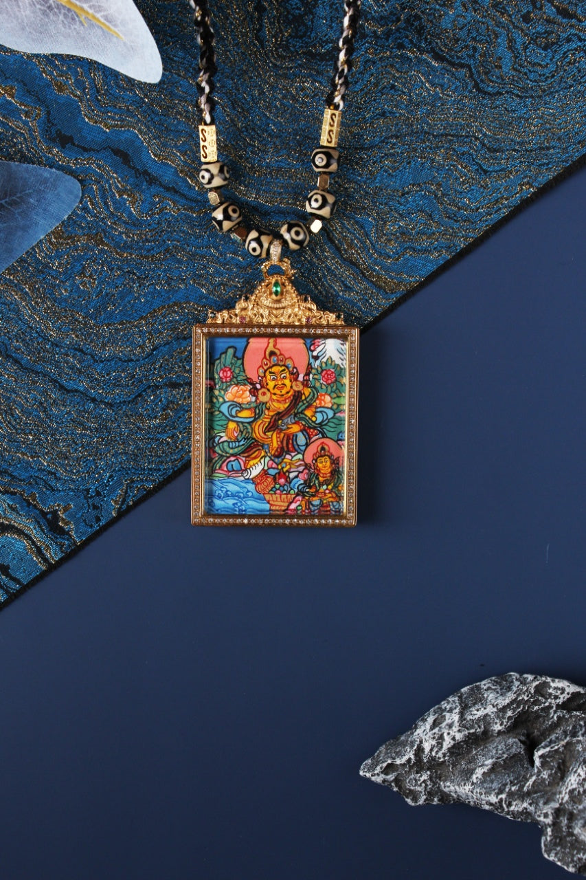  Detailed view of the exclusive 925 Sterling Silver casing for the Dual Yellow Jambhala Thangka pendant, symbolizing protection and elegance in Tibetan Buddhist tradition.

