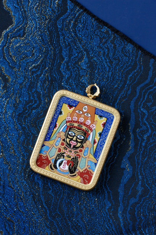 Tibetan thangka amulet featuring Dzaki Lhamo, the prosperity goddess revered in Tibetan Buddhism for fortune and blessings.