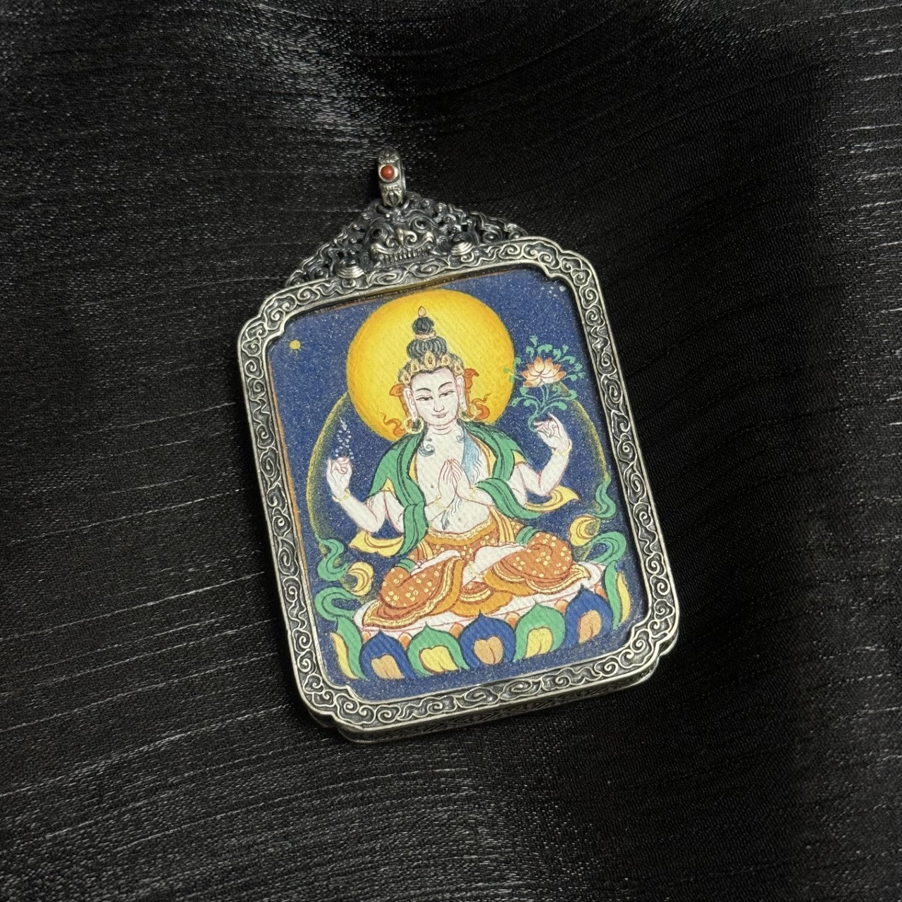  Close-up detail of the Bold Four-Armed Avalokiteshvara Thangka painting showing intricate natural mineral pigment work and symbolic attributes, showcasing the artistry of Tibetan lineage painters.