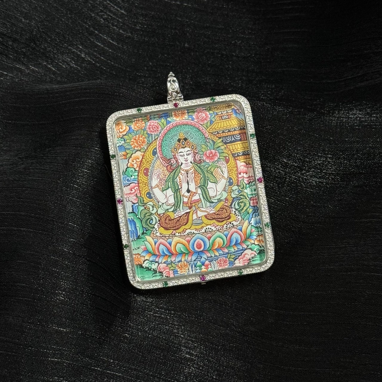  A 4x5cm hand-painted Four-Armed Avalokiteshvara with Eight Guardians and Mandala Thangka pendant featuring the embodiment of great compassion, representing family protection and peace in Tibetan Buddhist tradition.
