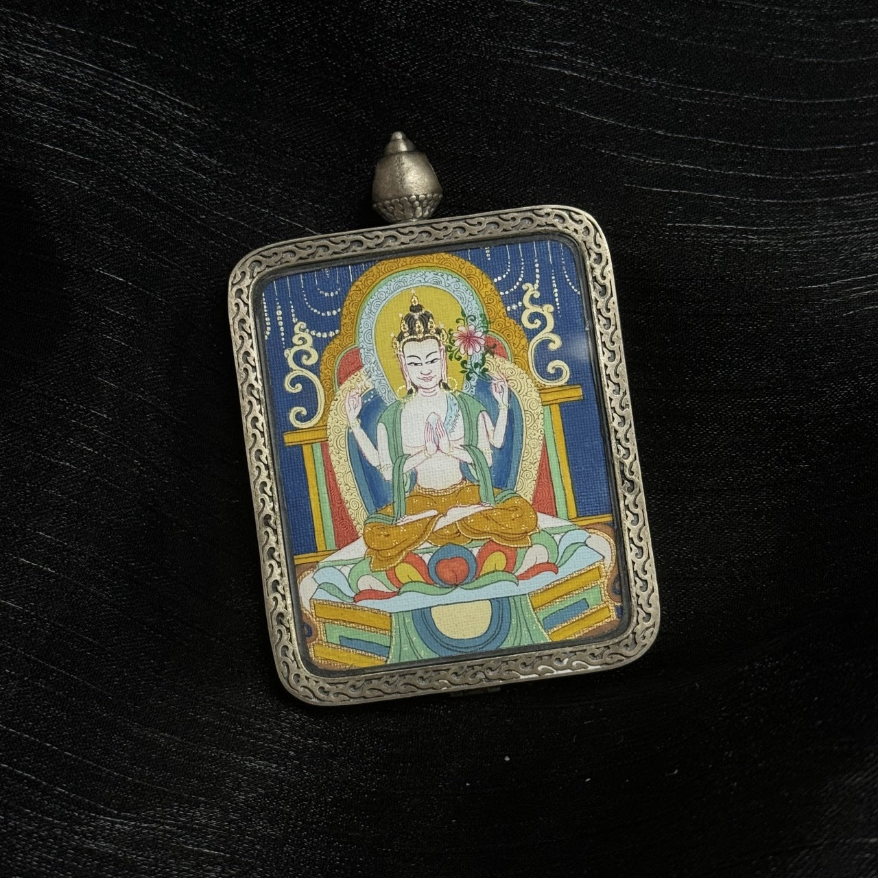  Close-up detail of the Karma Kagyu Four-Armed Avalokiteshvara Thangka painting showing intricate natural mineral pigment work and compassionate symbolism, showcasing the masterful artistry of Tibetan lineage painters.

