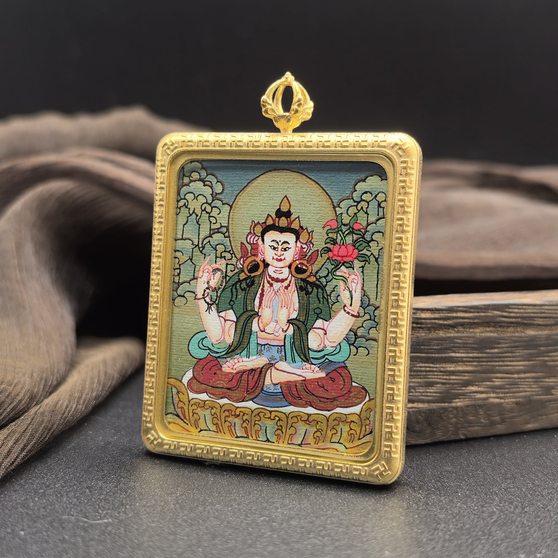 Detailed view of the titanium casing for the Four-Armed Avalokiteshvara Thangka pendant, symbolising compassion and tradition in Buddhist practice.
