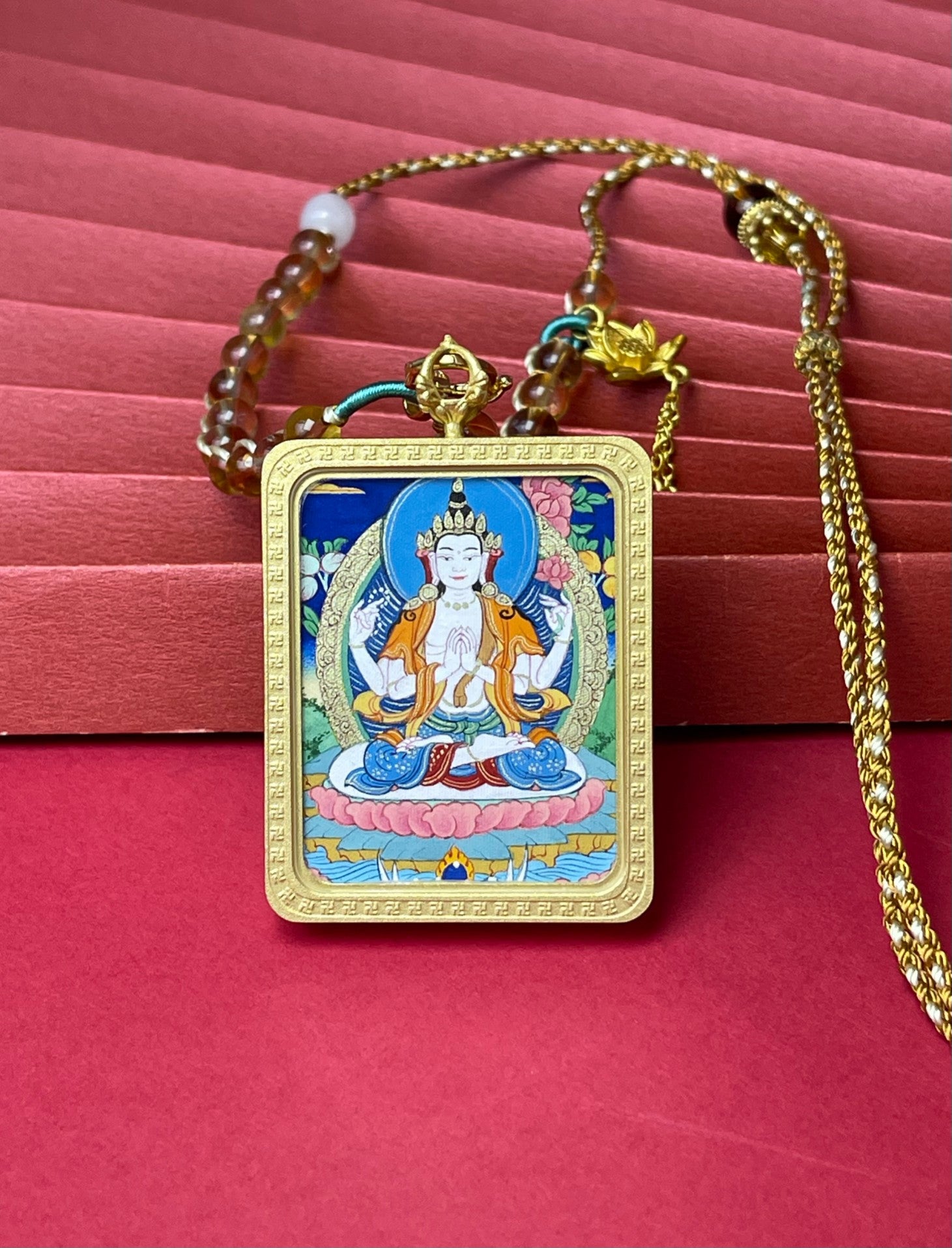 Close-up detail of the Rekong Four-Armed Avalokiteshvara Thangka showing hand-painted mineral pigments, showcasing the masterful artistry and colour stable for a hundred years.
