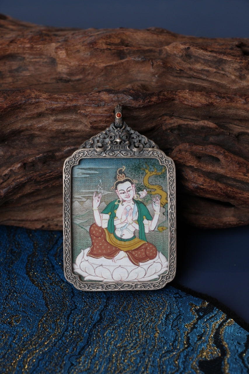 Thangka necklace portraying Four-Armed Avalokiteshvara, the bodhisattva of compassion guiding beings on the Tibetan Buddhist path.