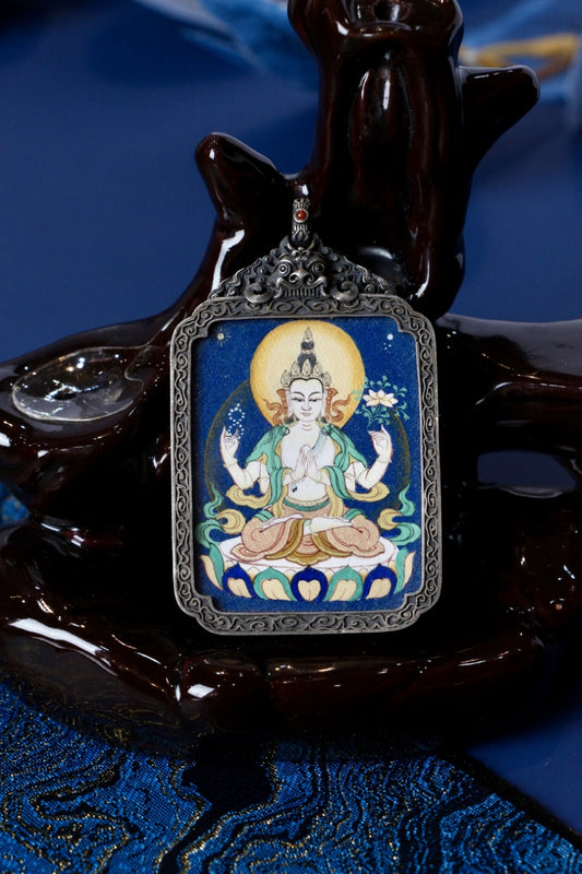 Tibetan thangka jewelry featuring Chenrezig, inspired by traditional Tibetan Buddhist sacred art.