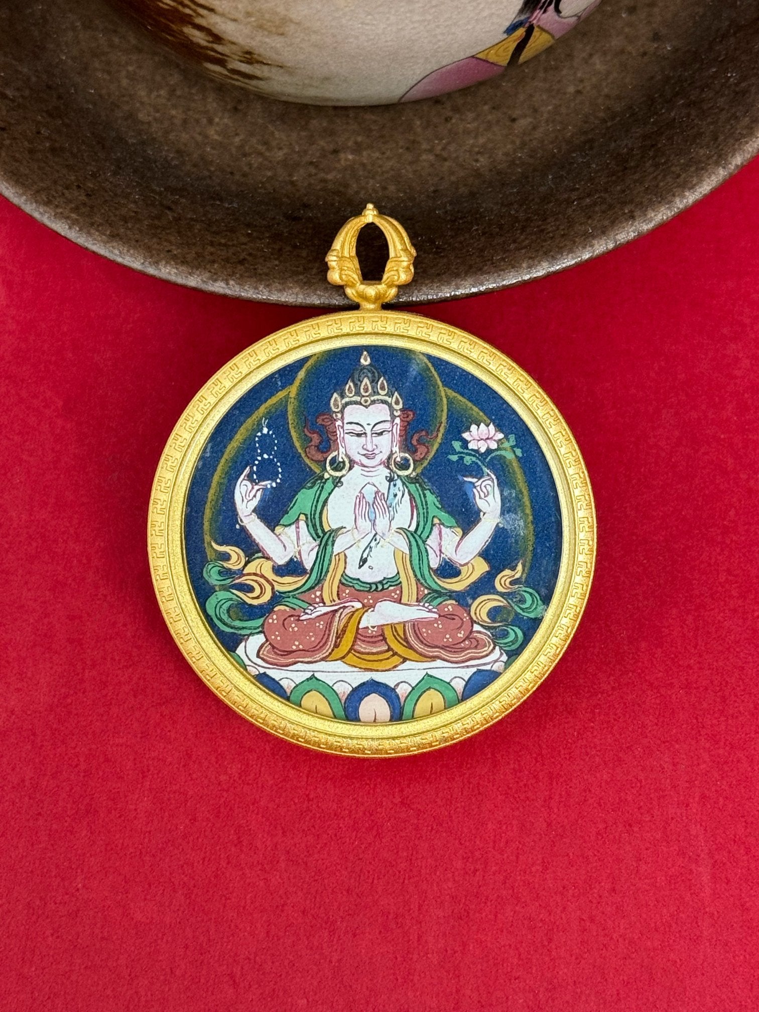  Close-up detail of the Tibet Bold Four-Armed Avalokiteshvara Thangka showing hand-painted mineral pigments, gold and lapis, showcasing the masterful artistry and three-dimensional imagery.

