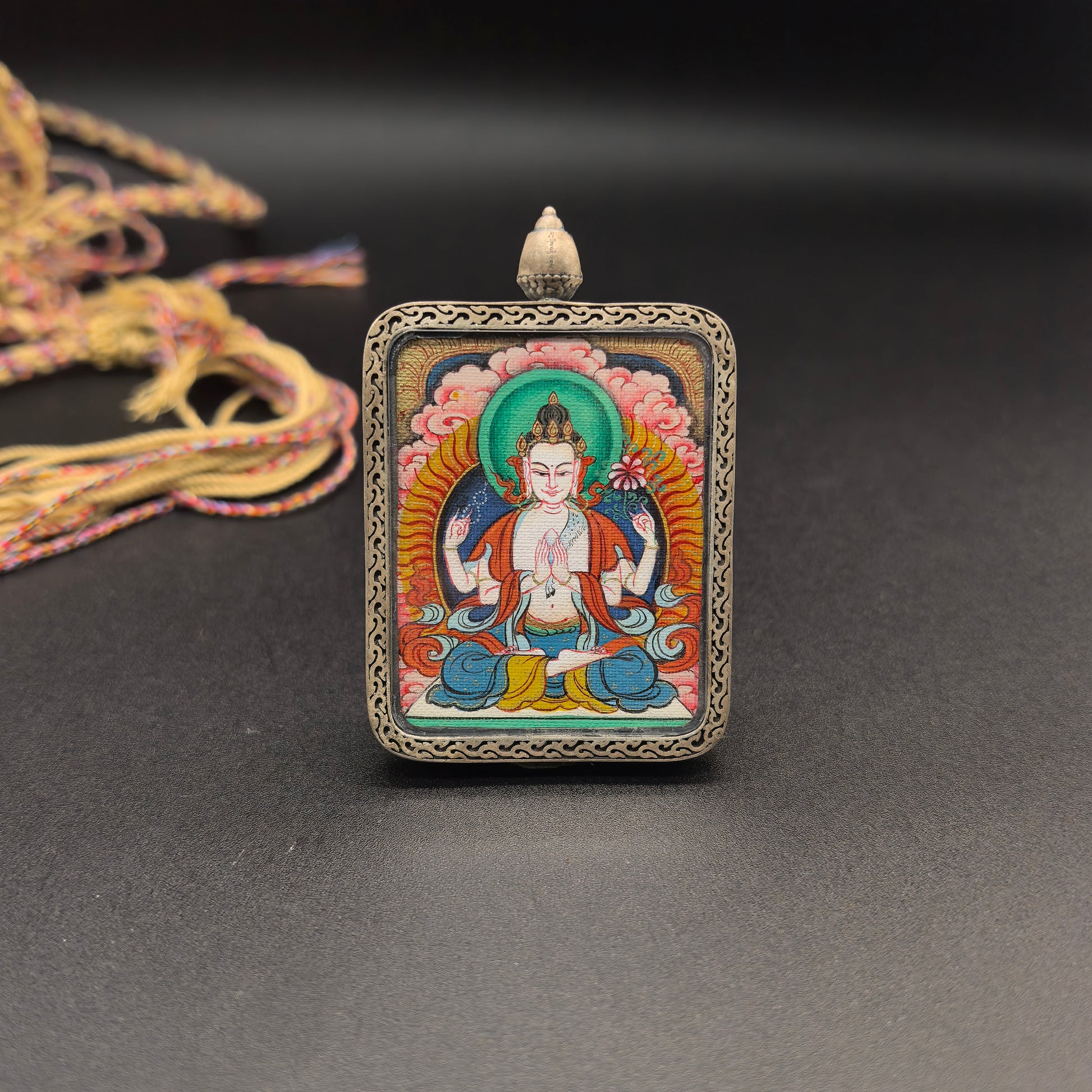 Close-up detail of the Tibet Red Cloud Four-Armed Avalokiteshvara Thangka painting showing natural mineral pigments, showcasing the masterful artistry of the hand-painted tradition.
