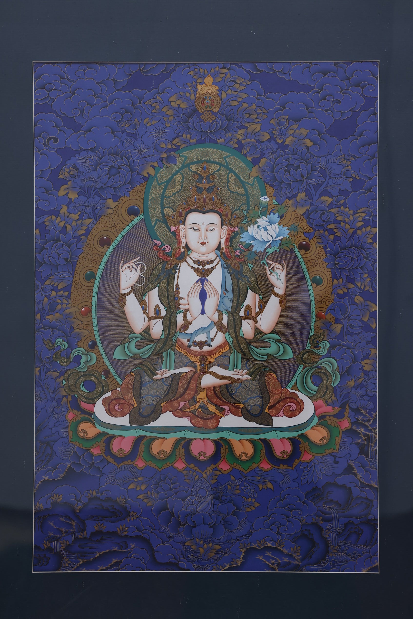 Sacred art Thangka of Four-Armed Chenrezig, hand-painted with natural mineral pigments, representing spiritual awakening.