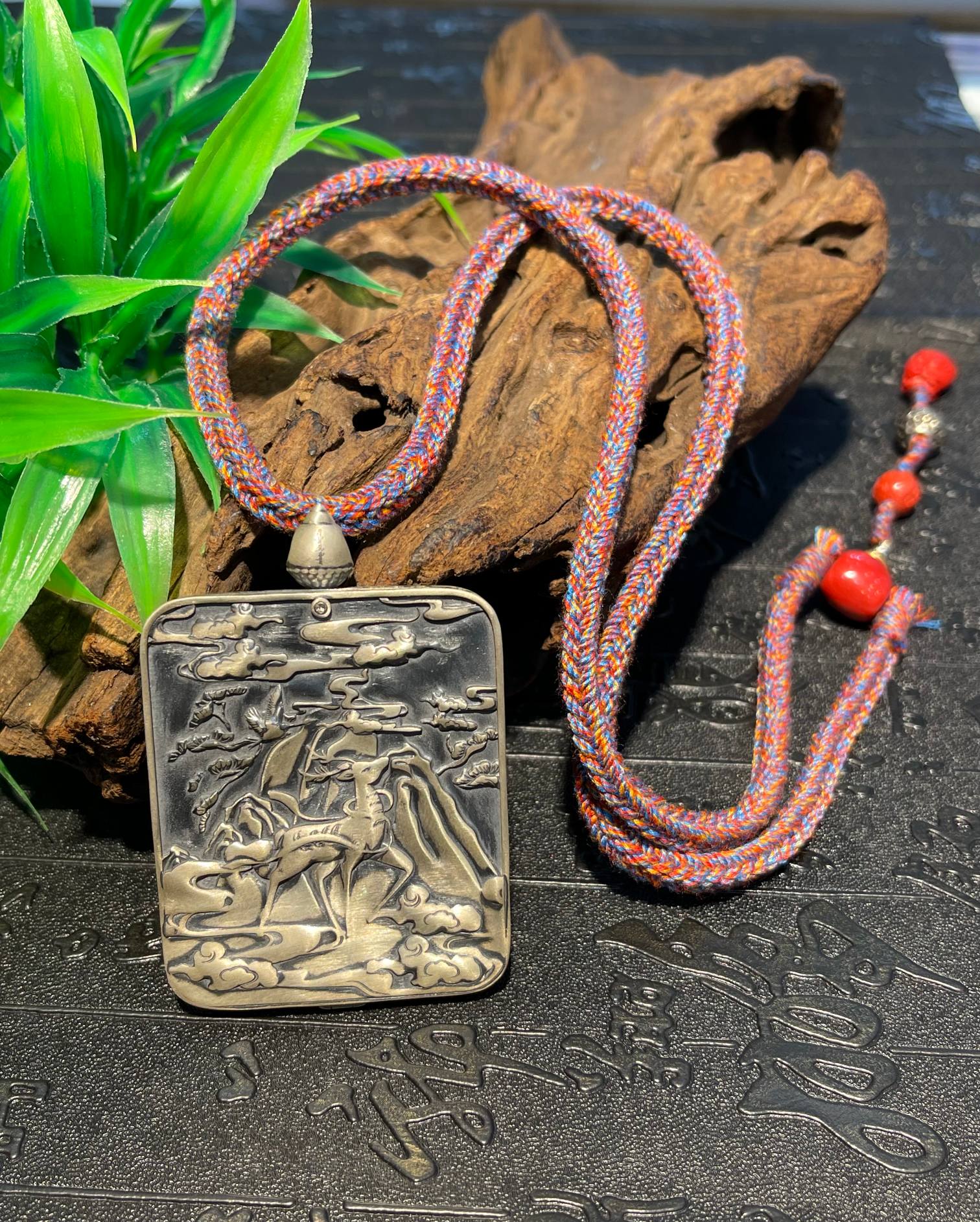 The Chigong Premium Ganesh 4x5cm pendant with nine-deer silver and cinnabar necklace displayed as an amulet for wealth and harmony.

