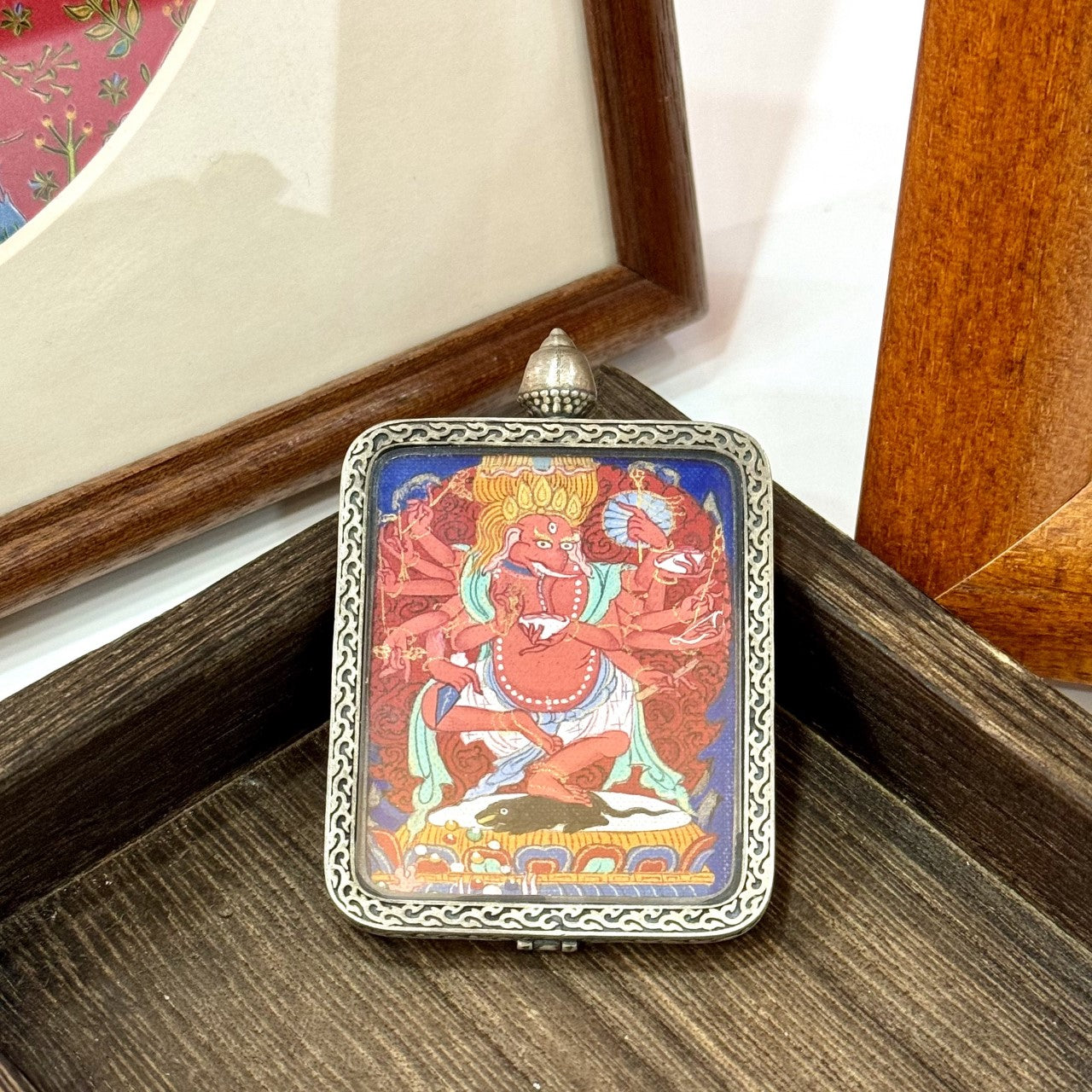Detailed view of the Dunhuang Nine-Color Deer silver casing for the Ganesh Thangka pendant, symbolizing protection and elegance in Tibetan Buddhist tradition.

