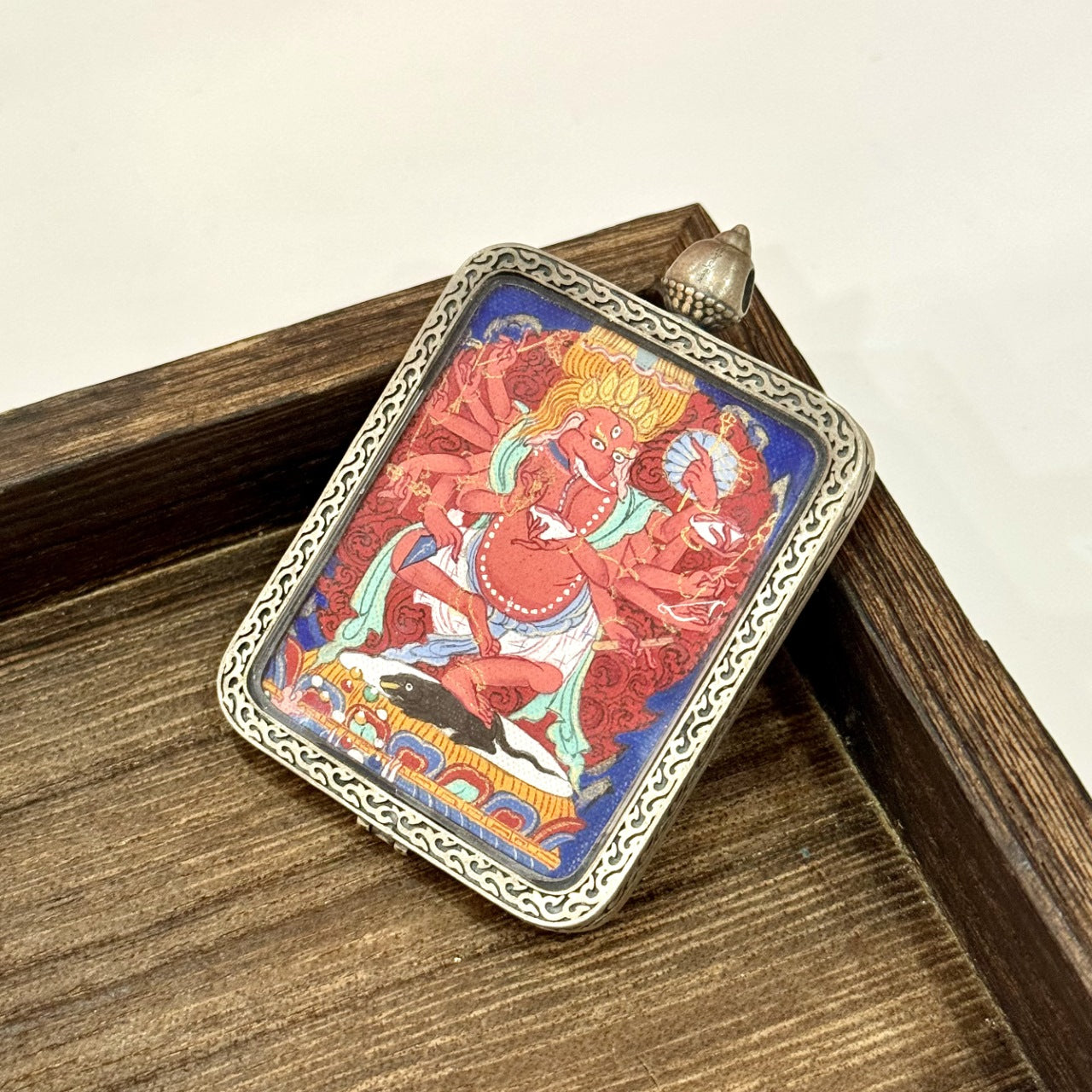 The Tibet Qigang Ganesh Thangka pendant displayed as a sacred amulet for success and prosperity, embodying Tibetan Buddhist tradition.
