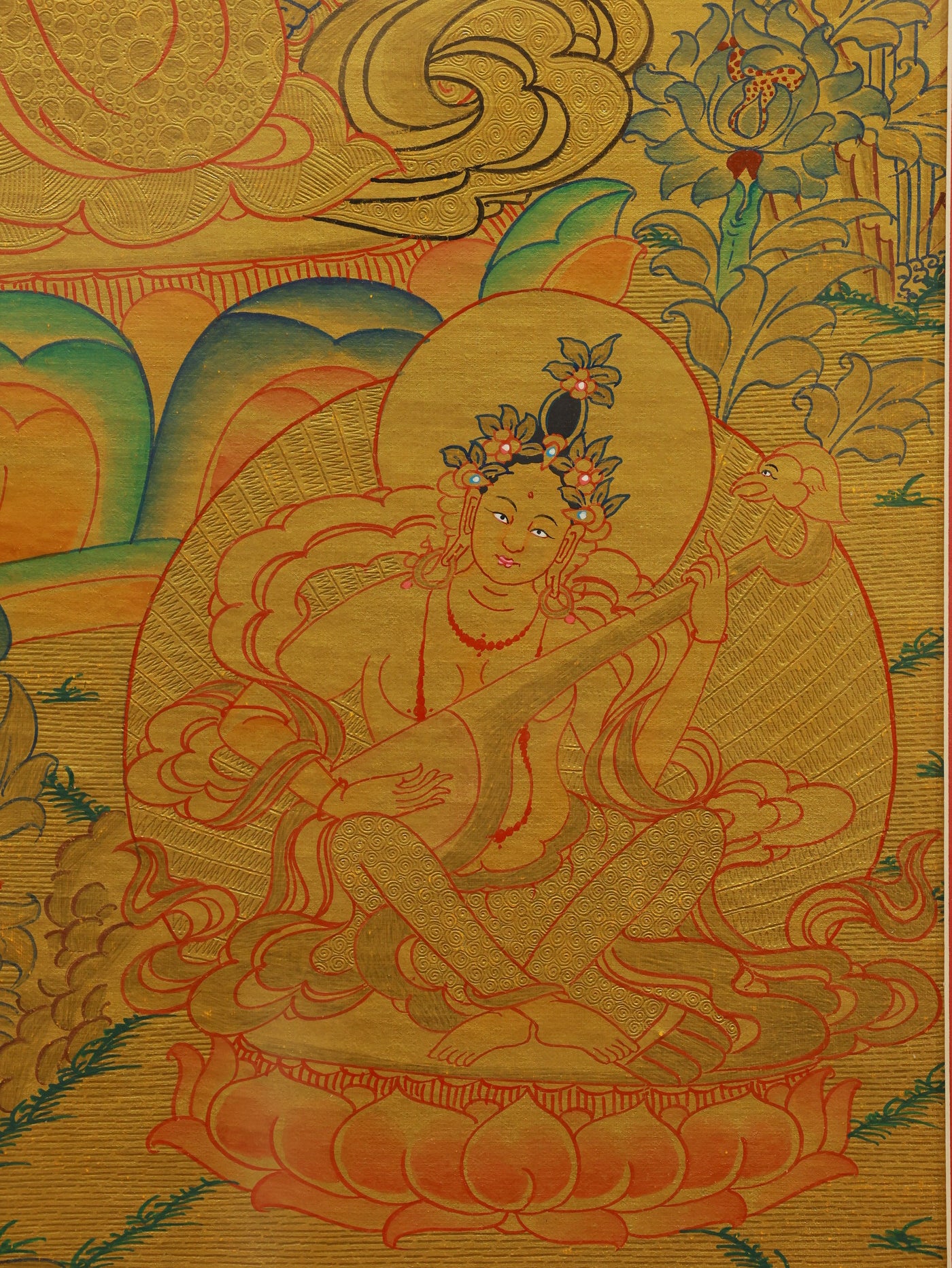 Authentic Tibetan gold thangka of Green Tara featuring sacred symbols and traditional Buddhist aesthetics