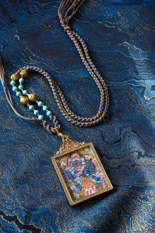 Mahakala thangka pendant depicting the wrathful protector deity in Tibetan Buddhism, symbolizing spiritual power and protection.