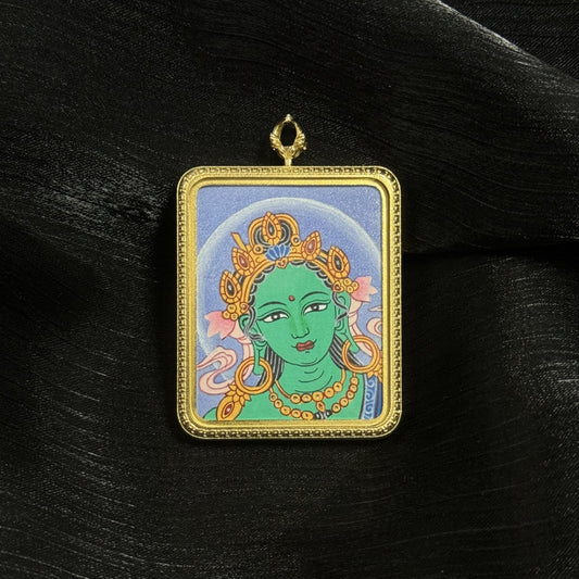  A 4x5cm hand-painted Nepal Bold Green Tara Buddha Head Thangka pendant featuring the Liberator from Eight Dangers, representing compassion and protection in Buddhist tradition.
