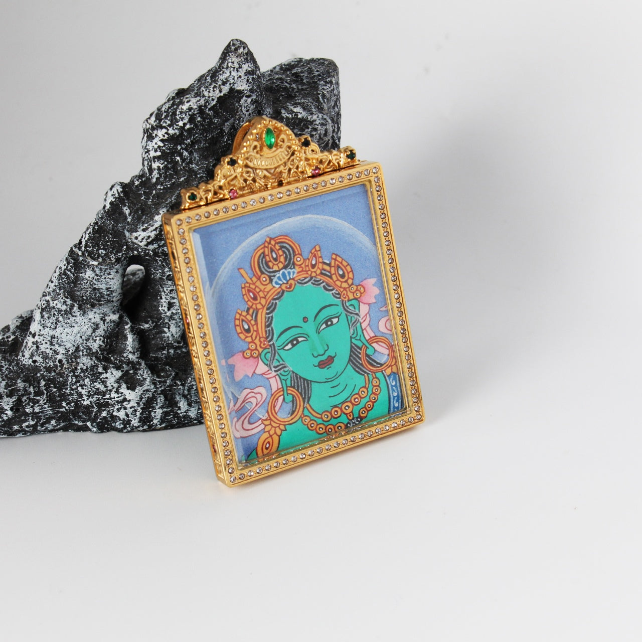 Hand-painted Nepal Bold Green Tara Buddha Head Thangka pendant featuring the Liberator from Eight Fears, encased in titanium steel, representing liberation and wisdom in Tibetan Buddhist tradition.