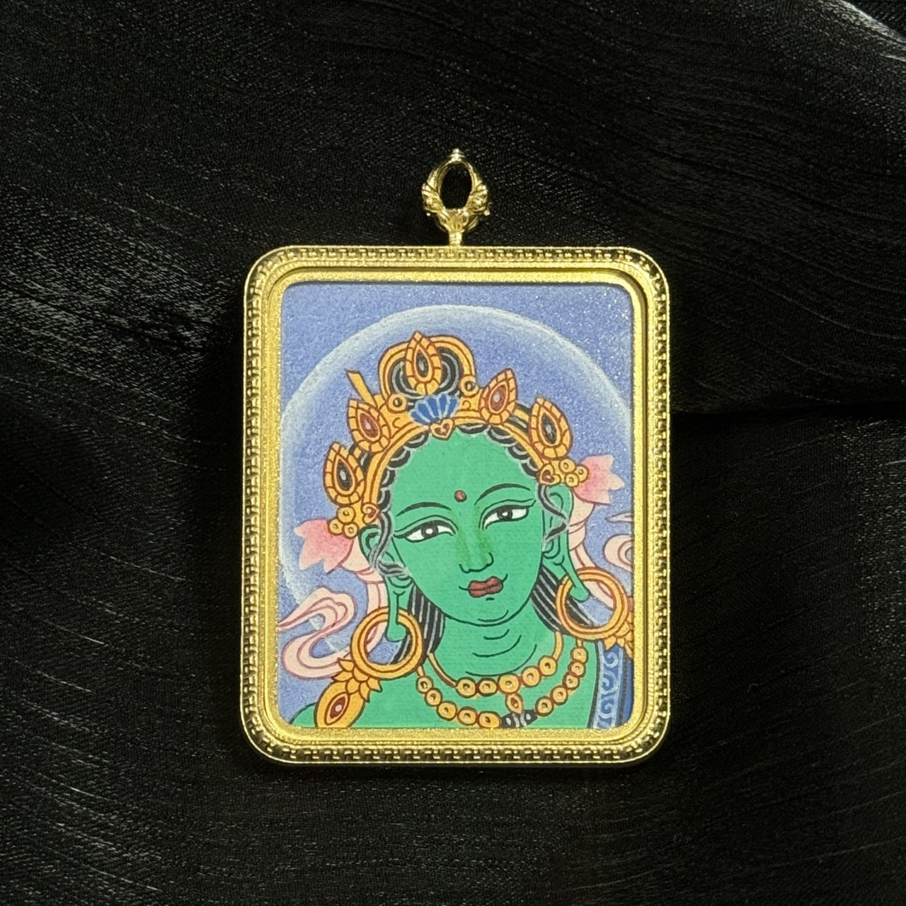 Detailed view of the titanium steel casing for the Green Tara Buddha Head Thangka pendant, symbolising protection and durability in Buddhist tradition.

