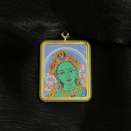  The Nepal Bold Green Tara Buddha Head Thangka pendant displayed as a sacred amulet for liberation and protection, embodying Buddhist tradition.
