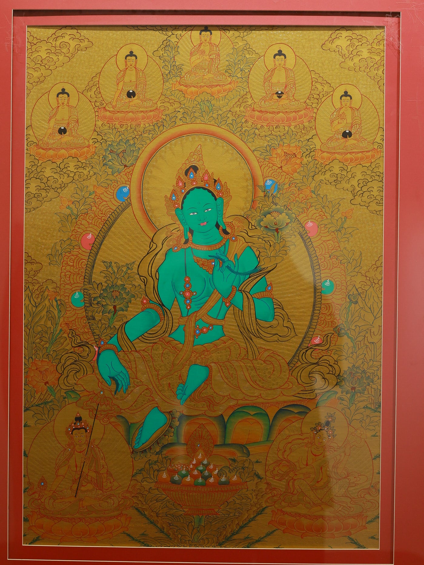Protector deity Green Tara illustrated in a traditional gold Tibetan thangka painting