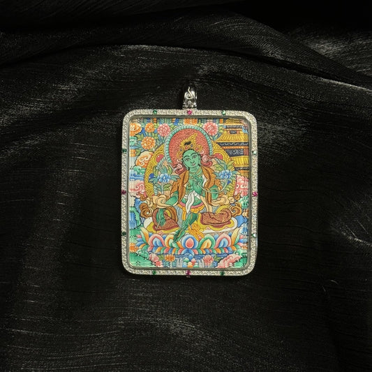  A 4x5cm hand-painted Green Tara with Mandala Thangka pendant featuring the Swift Liberator, representing love, career and harmony in Tibetan Buddhist tradition.
