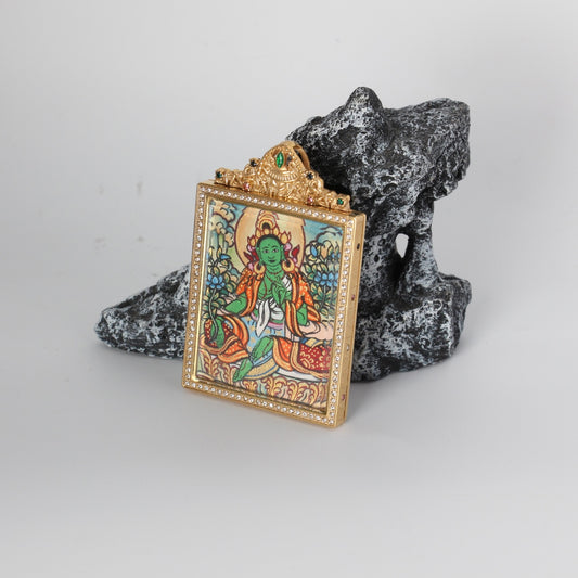 Hand-painted Nepal Elegant Green Tara Thangka pendant featuring the Goddess of Compassion and Swift Action, encased in titanium steel, representing compassion in Tibetan Buddhist tradition.

