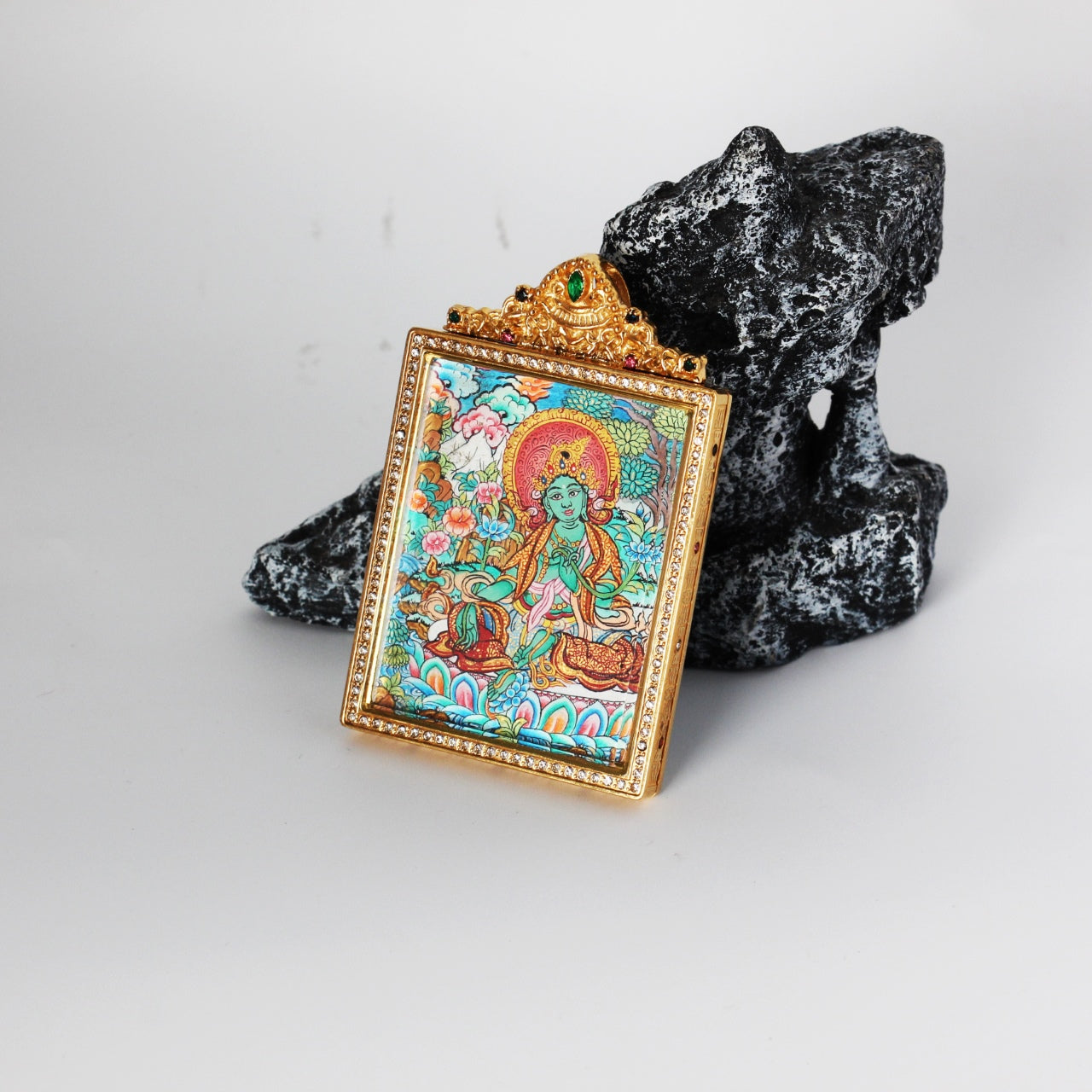  Hand-painted Nepal Premium Green Tara Thangka pendant featuring the Goddess of Compassion and Swift Action, encased in titanium steel, representing compassion in Tibetan Buddhist tradition.

