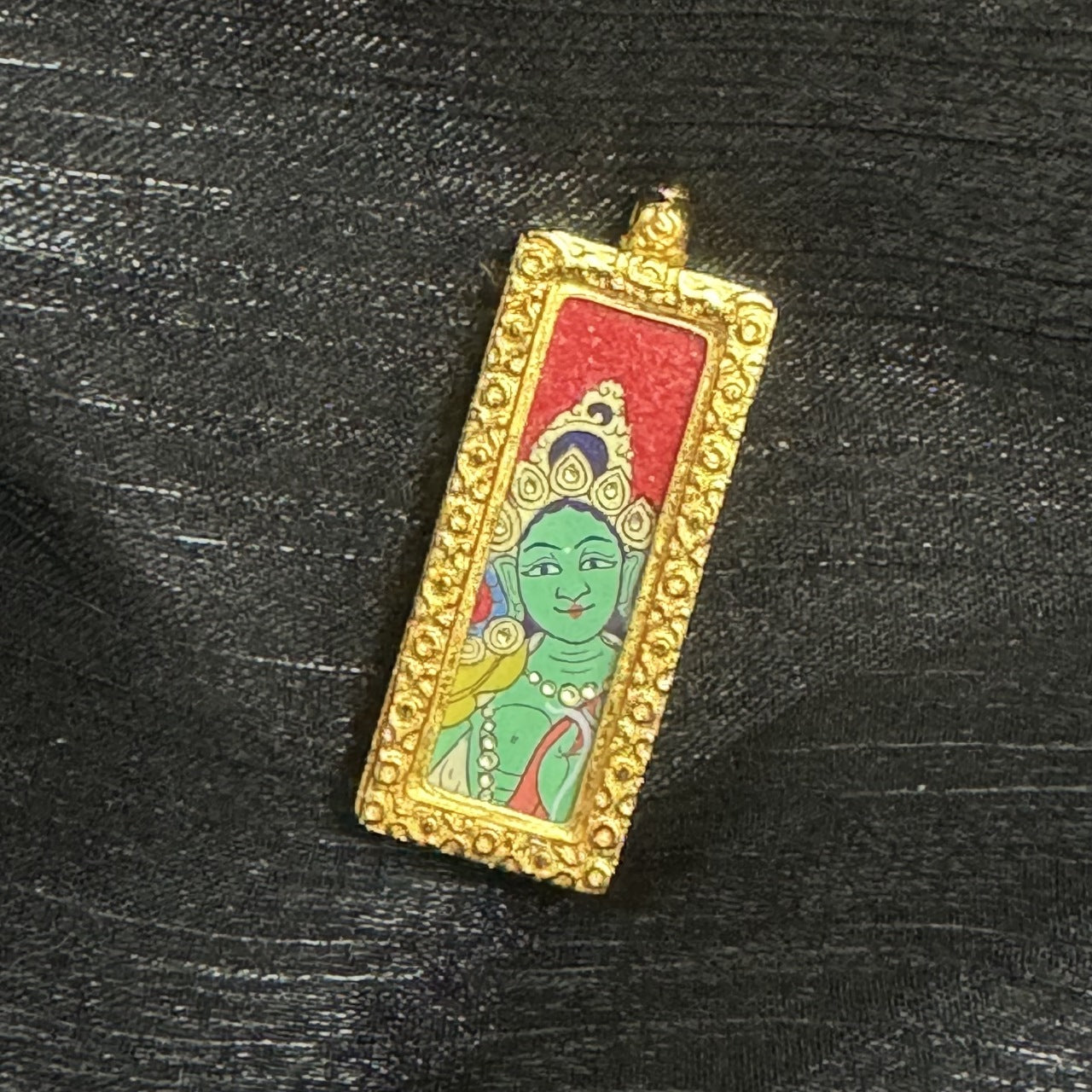 Hand-painted Rebgong Buddha Head Green Tara Thangka pendant featuring the goddess of compassion, encased in copper, representing love, career and blessing in Tibetan Buddhist tradition.

